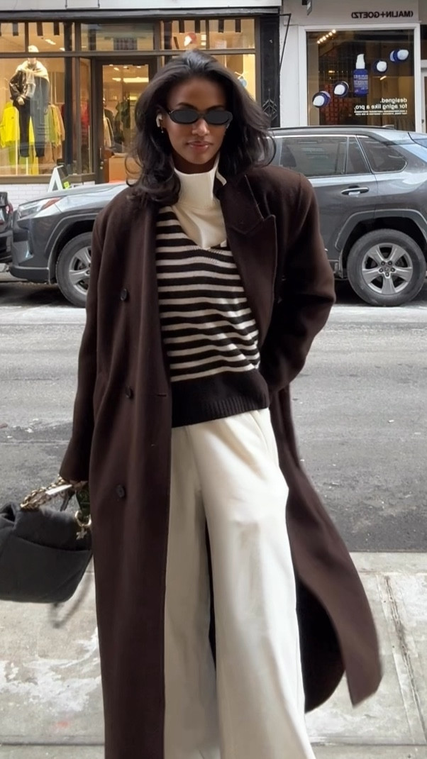 Rainy day in New York casual outfit. Nice wall trench, brown striped sweater layered with a Alo Yoga cream leisure set.