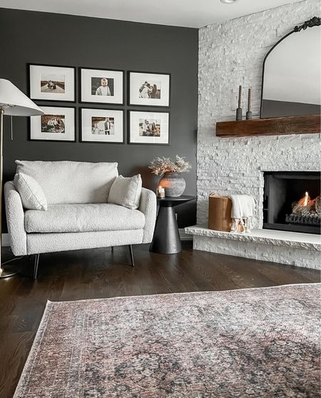 We have an angled fireplace wall, creating an awkward wall and corner in our room. I created a cozy corner by adding a large armchair, gallery wall, floor lamp, and side table.  

#LTKhome #LTKfindsunder100 #LTKstyletip