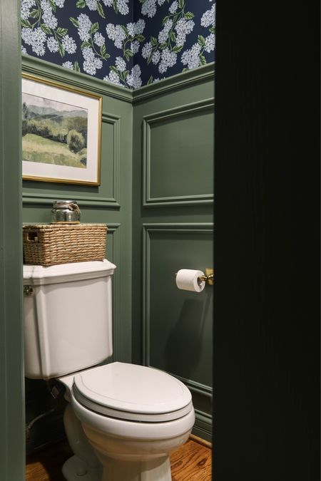 My powder room features navy hydrangea wallpaper and Calke Green paint. I love the way the gold fixtures and picture frame look with the decor.

#LTKhome