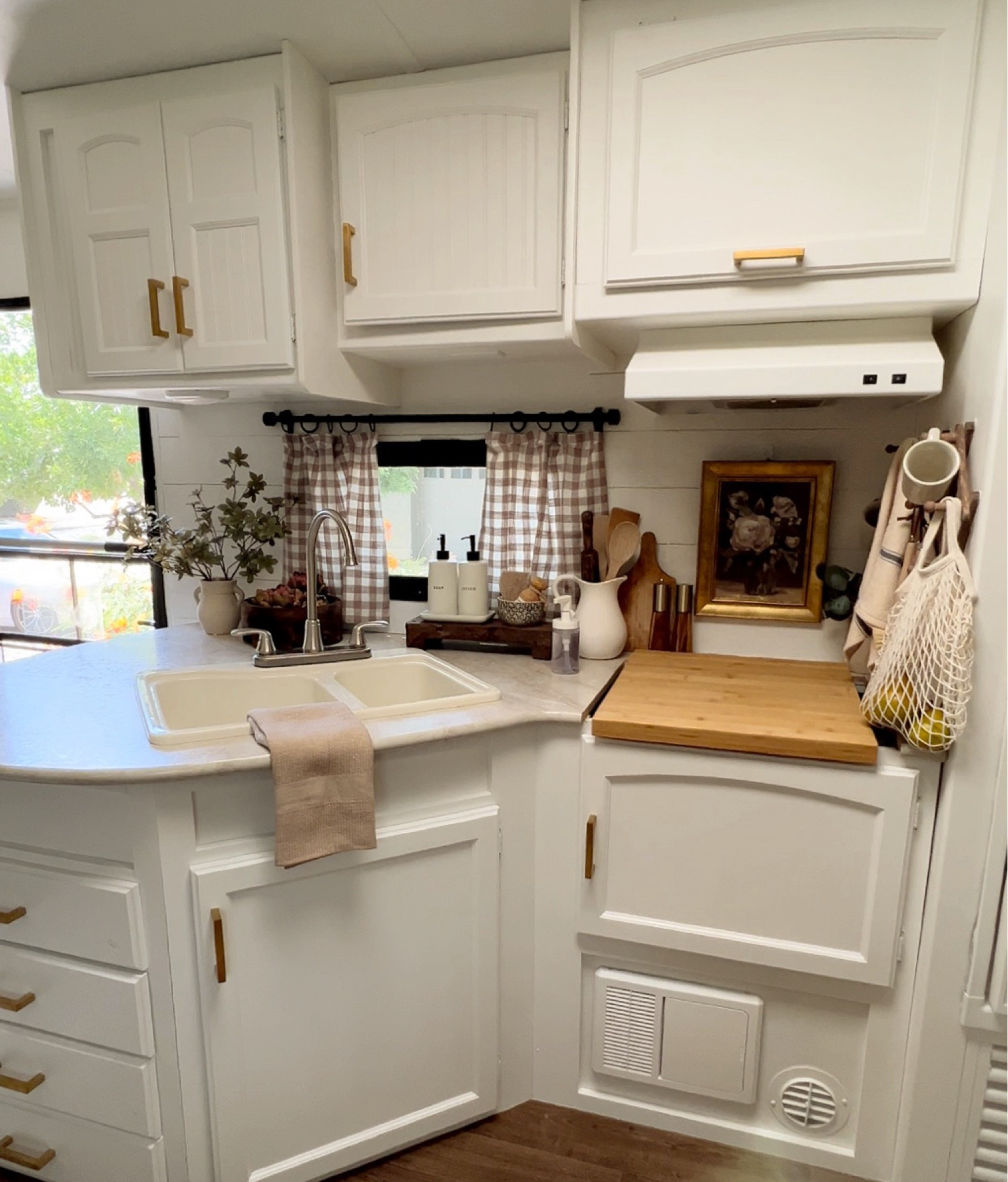Camper kitchen space decorated for fall with affordable finds. RV, Threshold, Studio McGee, Hearth & Hand, wooden bowl, gingham napkins, faux plant, floral arrangement, soap dispenser, lotion dispenser, wall art, artwork, modern farmhouse, cottage, fall decor, camping, glamping 

#LTKhome #LTKSeasonal #LTKstyletip