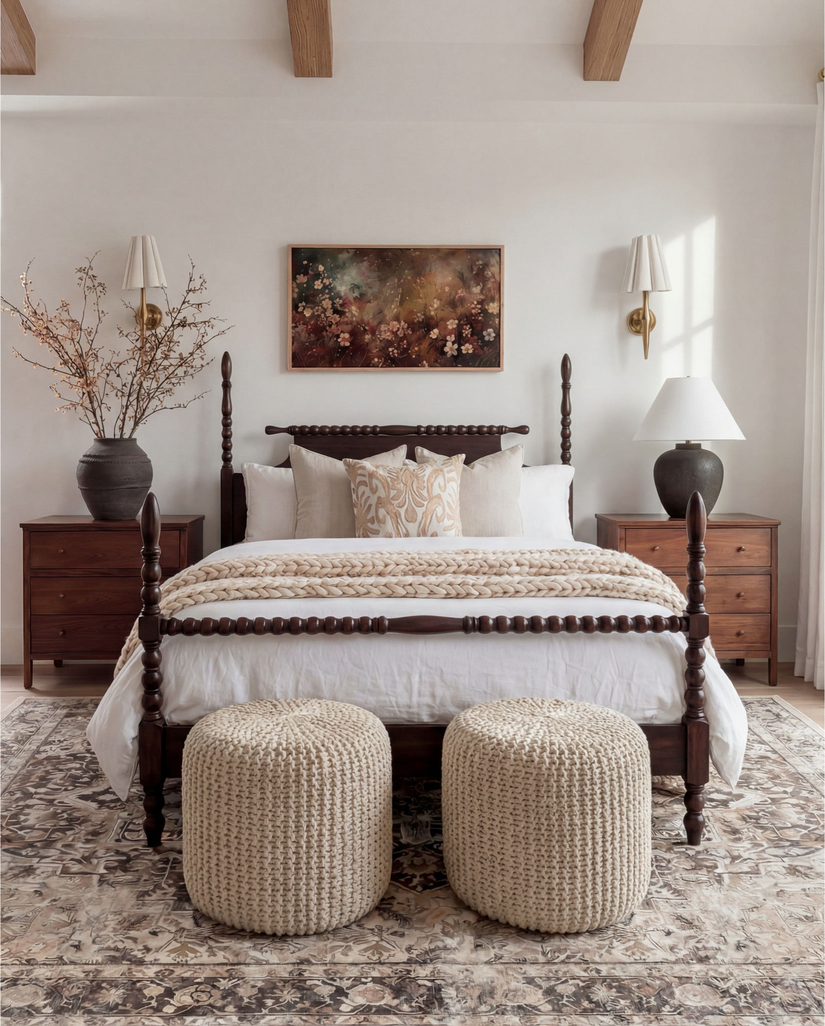 • Dark wood spindle bed frame
• White cotton duvet cover + pillow shams
• Neutral patterned area rug
• Cream Chunky knit throw blanket (warm beige)
• Woven knit poufs ottomans (bedside or bench seating)
• Wood nightstands with brass knobs
• Black ceramic table lamps
• White tapered lamp shades
• Brass wall sconces
• Framed floral wall art
• Textured accent throw pillows (neutral tones)
• Ceramic decorative bowl (white sculptural style)
• Wood bead garland with tassel
• Natural wood ceiling beams
• Light wood flooring

#LTKSaleAlert #LTKFindsUnder100 #LTKHome