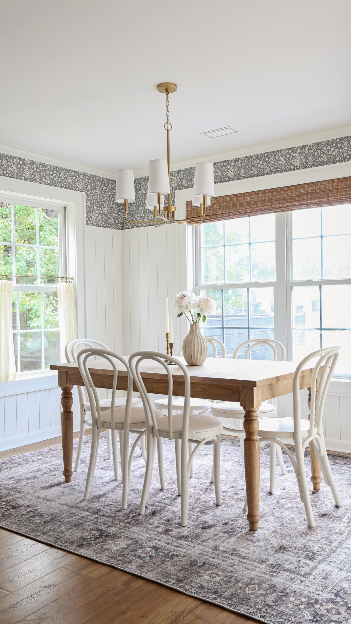 Details from my dining room makeover including our floral wallpaper, vertical shiplap wall, brass light fixture, bamboo blinds window treatment, cafe curtains, and French inspired wooden dining room table

#LTKHome #LTKStyleTip