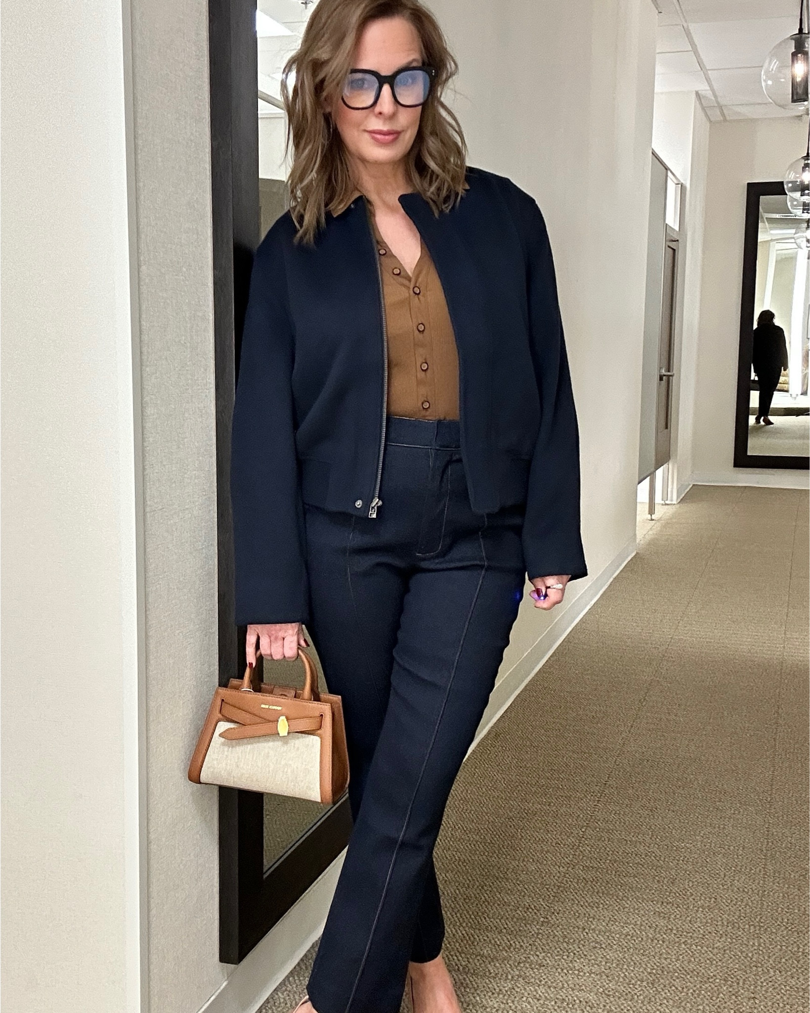 Deep dark denim looks so RICH. I added a Nordstrom brand navy bomber to these Veronica Beard ankle flare pants and cotton button-up. The cognac pumps coordinate perfectly with the stitching in the trousers and the bag will take you into spring, lightens the look. 
I sized up to a six in the Veronica Beard pieces  (holiday lbs). The bomber is a small, true to size.

#LTKStyleTip #LTKWorkwear #LTKShoeCrush