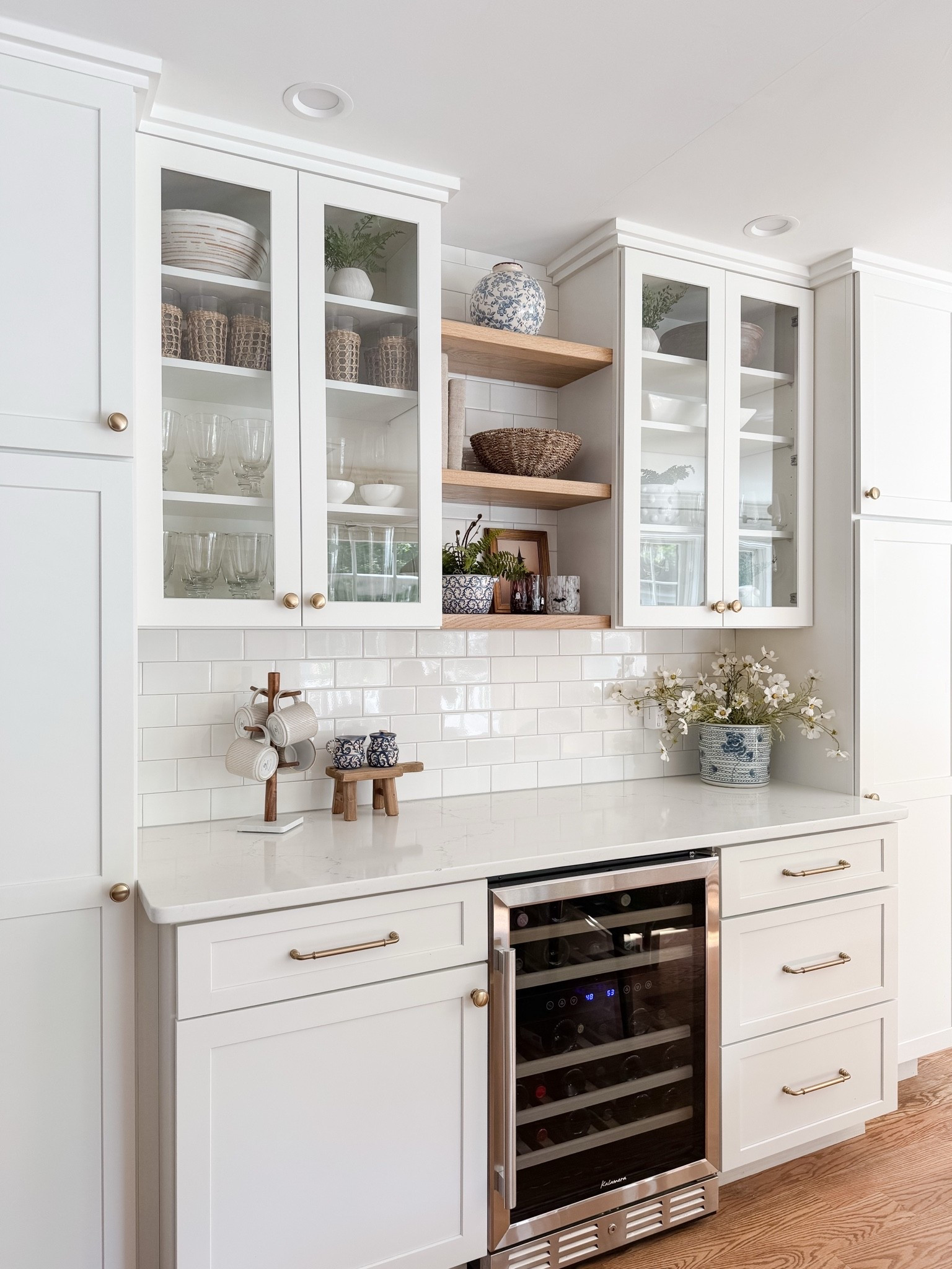 Built in cabinet styling with soft neutrals, glass fronts, and warm wood shelving that adds texture without clutter. This cape cod coastal kitchen keeps everything light, layered, and beautifully organized. Cape cod kitchen, coastal kitchen cabinets, glass cabinet styling, neutral kitchen decor, open shelf kitchen styling, amazon finds home decor, coastal neutral kitchen, sherri calnan home

#LTKHome
