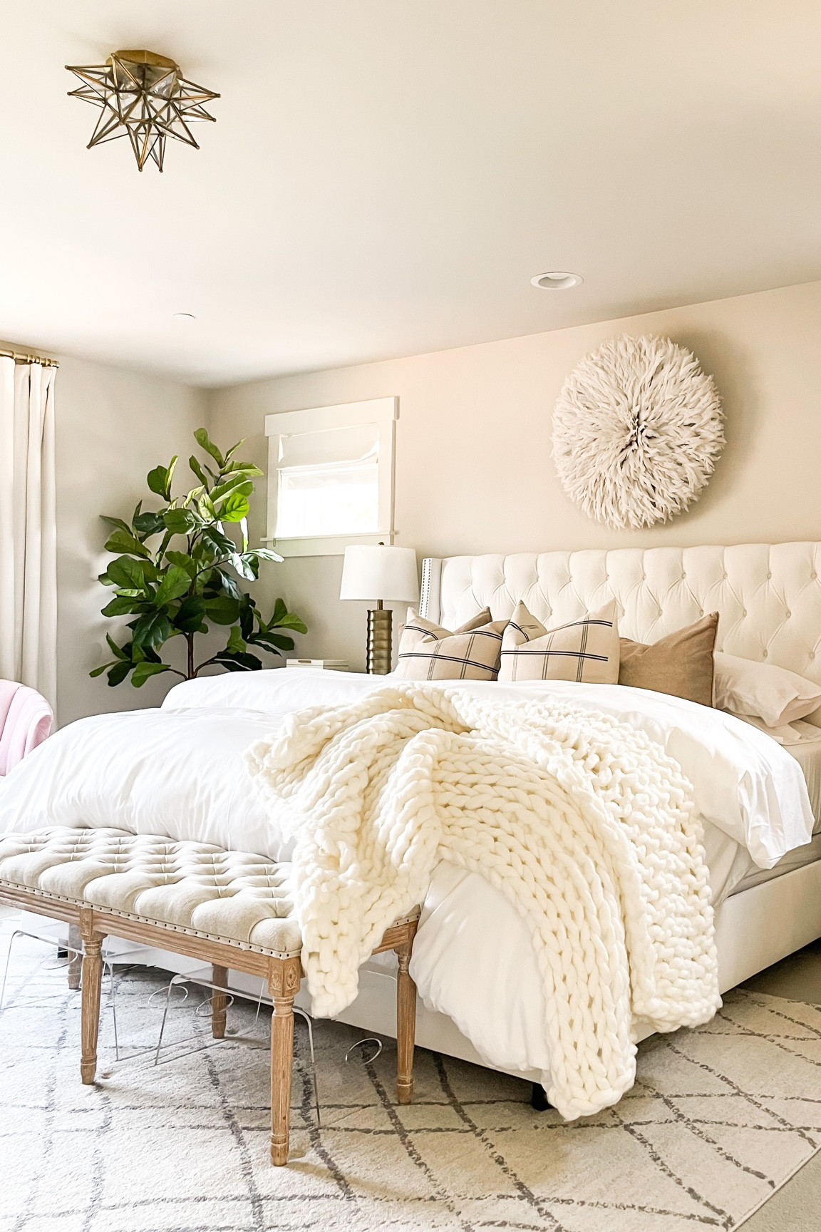 Neutral primary bedroom decor, Juju hat, white tufted bed frame , wooden bench, chunky knit throw, faux fiddle leaf tree! 

#LTKunder100 #LTKFind #LTKhome