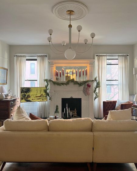 Living room Christmas decor, white couch, garland, mantle mantle, fireplace, chandelier, frame tv 

#LTKsalealert #LTKstyletip #LTKhome
