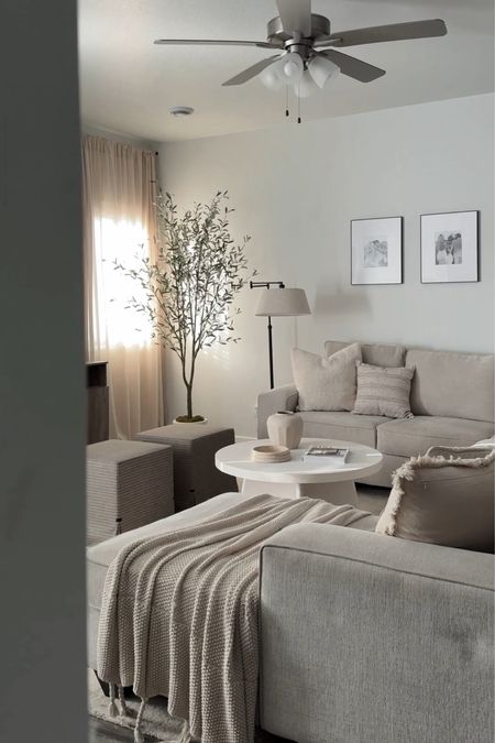 Neutral living room decor, white coffee table, plaster coffee table, apartment decor, round coffee table, olive tree, living room sectional 

#LTKhome #LTKsalealert #LTKfindsunder100