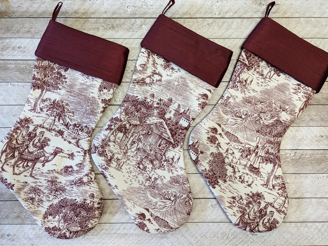 Set of three burgundy and cream nativity toile Christmas stockings with stable scene, wise men, s... | Etsy (US)