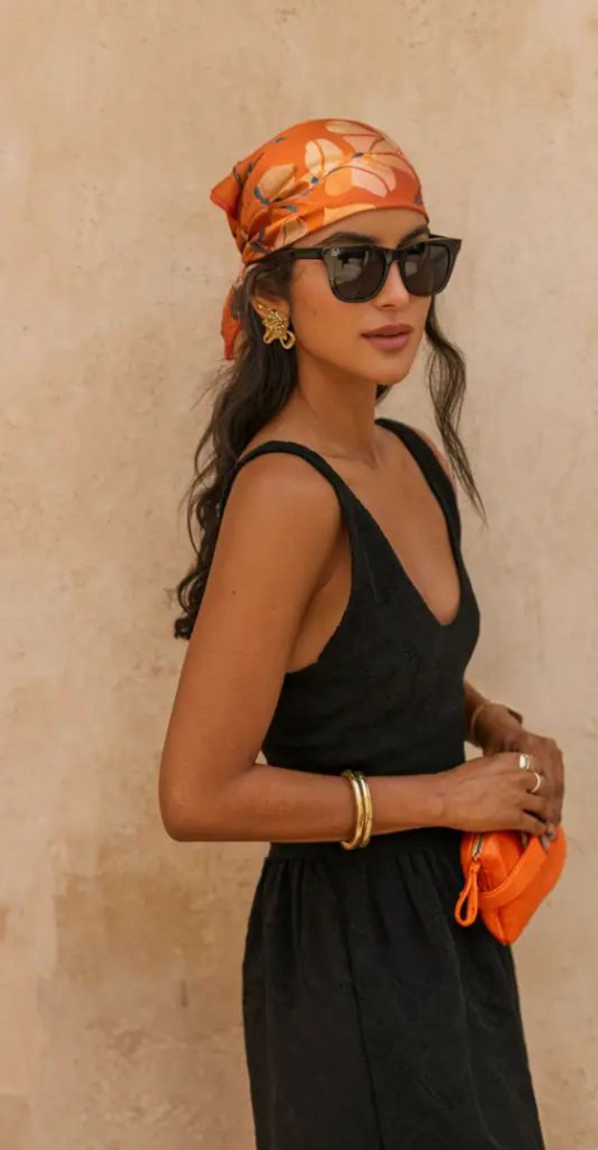 Bandana scarf styling for summer ☀️🧡 A printed silk scarf instantly makes even the simplest black outfit feel elevated and vacation-ready. Paired with oversized sunglasses, gold jewelry, and a pop of orange for that effortless European summer aesthetic ✨ #bandanastyle #scarfstyle #europeansummer #vacationstyle #summeraccessories #coastalchic #quietluxury #resortstyle #ltkstyle 

 #LTKootd #LTKSeasonal