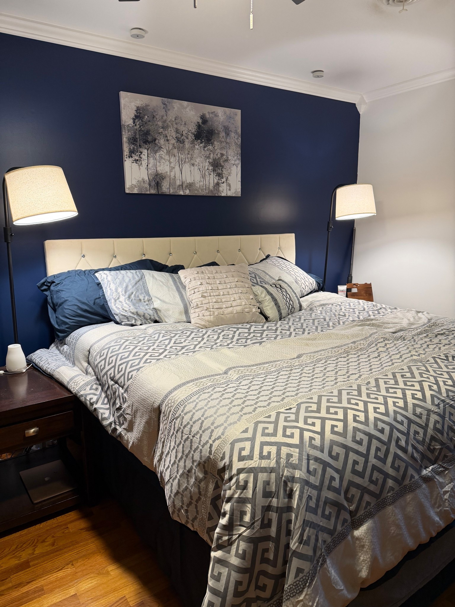 Master bedroom. Navy, grey, white and beige colors. Wood bedside stands, velvet headboard, classic lamps, abstract art and abstract comfort bedding. Shop my links! 

#LTKHome