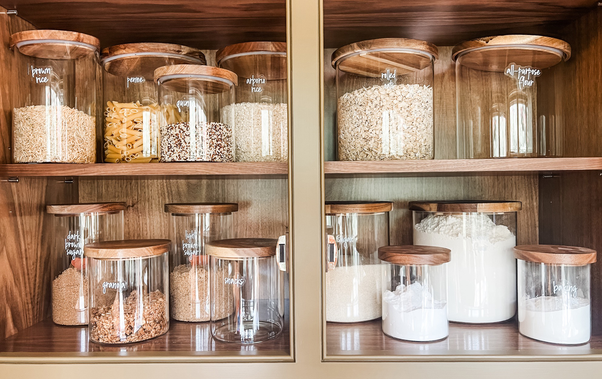 We're firmly Team Decant. There's some upkeep but really, unless you are blowing through bags of baking or spices on a weekly basis, we promise it's not that much. The pros are many (freshness, visibility, and the pretty factor) and if you are worried about expiration dates, it's easy enough to pop a little label on the back. 

One last pro tip: When restocking, empty out the older contents into a bowl, drop the new in first, and then add the older back in on top. 

 