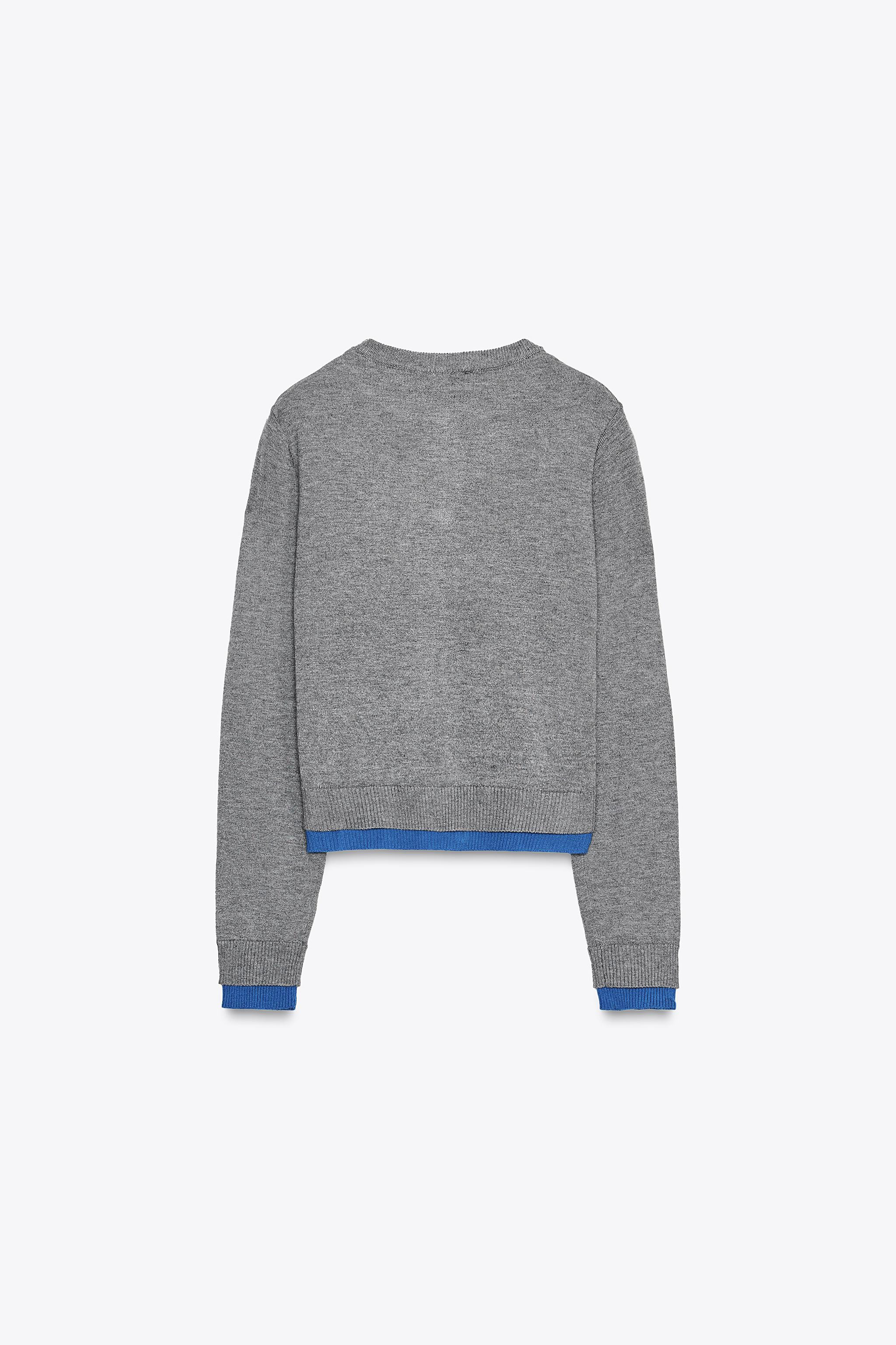 Round neck long sleeve jumper with buttoned cuffs. Ribbed trim. | Zara US