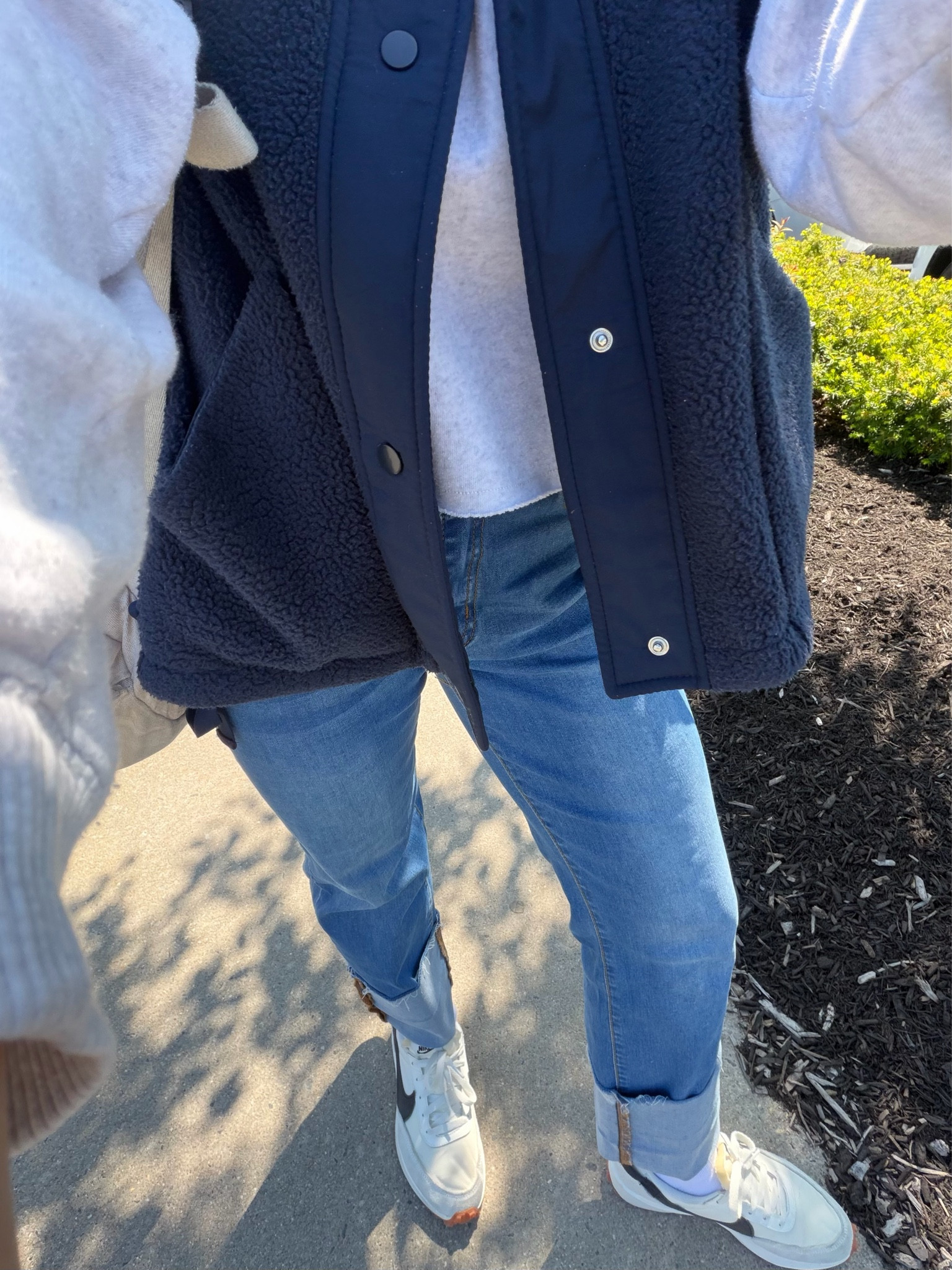 The weather in NJ has been so annoying going from hot 80 degree days to cold 30s! 

The only way to manage unpredictable weather is dressing in layers- which is why I literally LIVE in this cozy oversized fleece vest! 

I throw this FP look-a-like oversized vest on over everything- all year round- I even wear it in the house! It’s warm, cozy, and big enough to fit over bulky sweatshirts, making it a great layering piece!

Another closet staple is this lightweight, cropped, raw hem crewneck sweatshirt from @American Eagle Outfitters (TTS- I’m wearing a Small)

The wide fold on the bottom of these Kunmi jeans is so on trend for 2026! The jeans are very stretchy & fit TTS

Throw on a simple pair of @Nike US  Waffle Debut sneakers (TTS) and you’re ready to run errands or enjoy a casual day out! 


SIZING 📏
• Sneakers: TTS
• Jeans: TTS (i’m wearing size 4- usually I’m a 26)￼
• cropped sweatshirt: TTS (S)
• Sherpa Vest: oversized (I’m in between an XS & S so I went with size Small bc I’d rather it be slightly big than too small. I could have prob even gotten away with a M if i wanted it REALLY cozy)


.
.
springfashion #outfitinspo #amazonfinds #oversizedvest 
travel outfits 
comfy airport outfit 
2026 casual spring outfit women
spring fashion 2026
mother’s day gift ideas
spring wardrobe staples
designer-inspired women’s fashion
@amazonfindsandfashion 

#LTKmomlife #LTKootd #LTKMothersDay