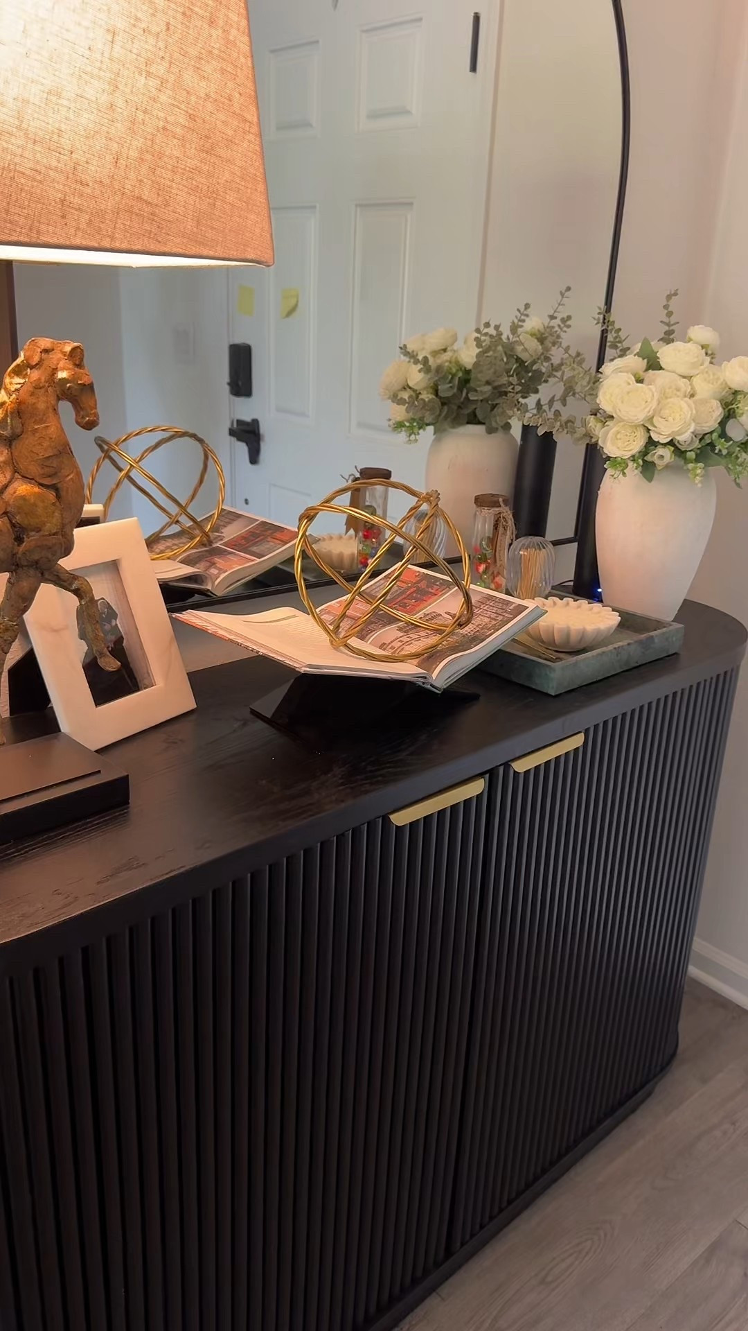 In French culture, the entrée isn’t just a place to drop your keys—it’s the first chapter of your home’s story. A well-styled entryway is meant to reflect the soul of the family who lives there. I love that sentiment.

I wanted ours to feel warm, thoughtful, and just a little bit timeless—with subtle nods to old-world charm:

A rounded mirror for softness and balance
A sculptural lamp and antique-inspired horse that hint at collected, storied pieces
florals for life and elegance
A favorite candle to create that inviting first impression

This space sets the tone every time we walk through the door. Everything is linked if you’re curating your own entryway story 
#ParisianDecor #FrenchInspired #EntrywayGoals #CollectedHome #SoftAutumnStyle #ParisianStyle #HomeWithHeart #DesignDetails #InteriorInspo

#LTKHome #LTKStyleTip #LTKFindsUnder50 #LTKHome