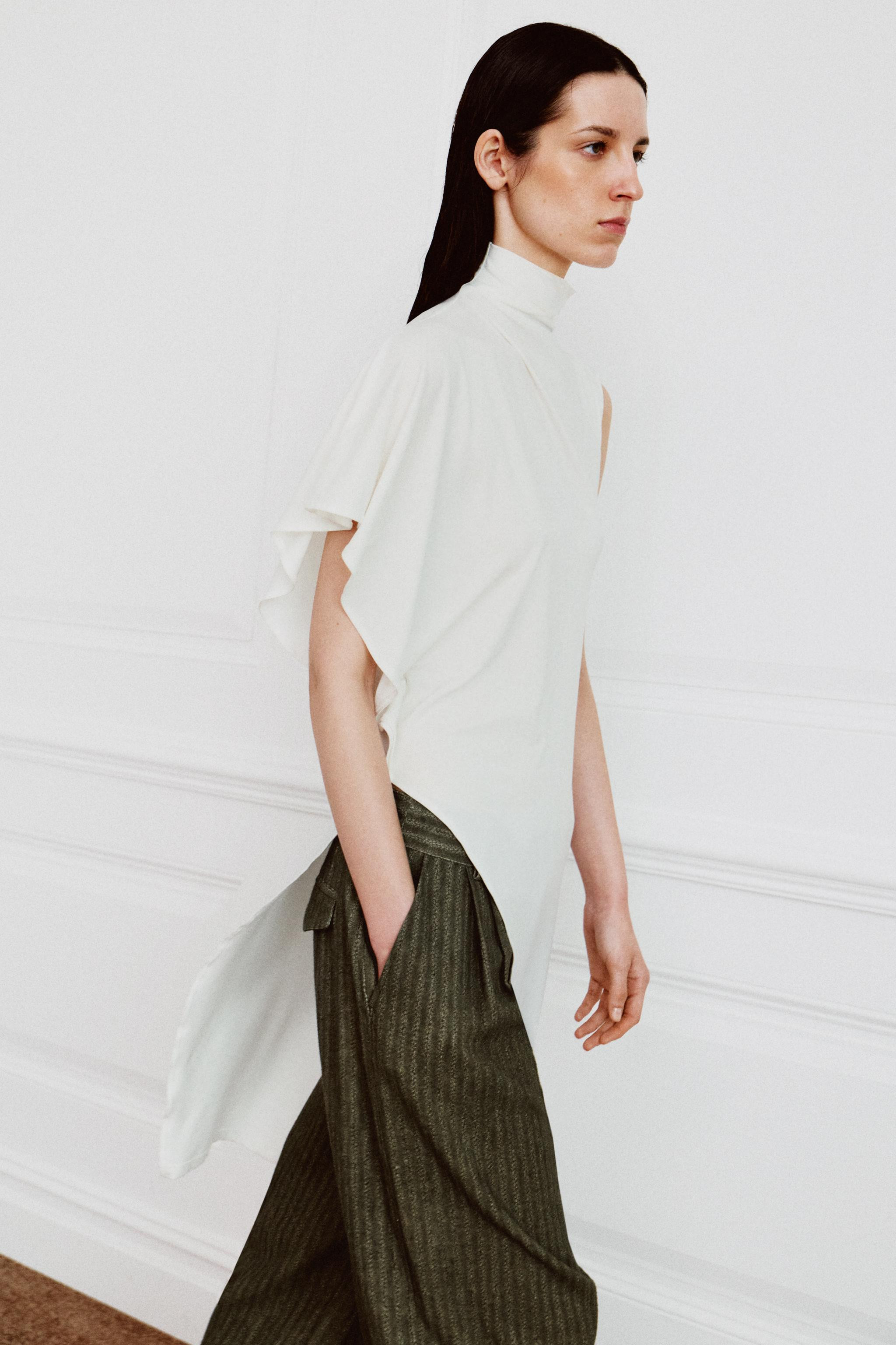 Long top made from lyocell blend yarn. High neck with one short sleeve and one sleeveless armhole... | Zara US