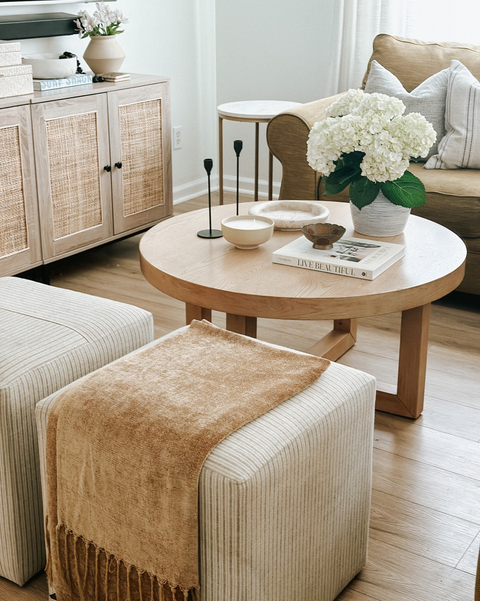 Loving the new spring touches for our living room nothing better than fresh hydrangeas // ottomans and round table from Studio McGee and Target such great versatile pieces for your home 