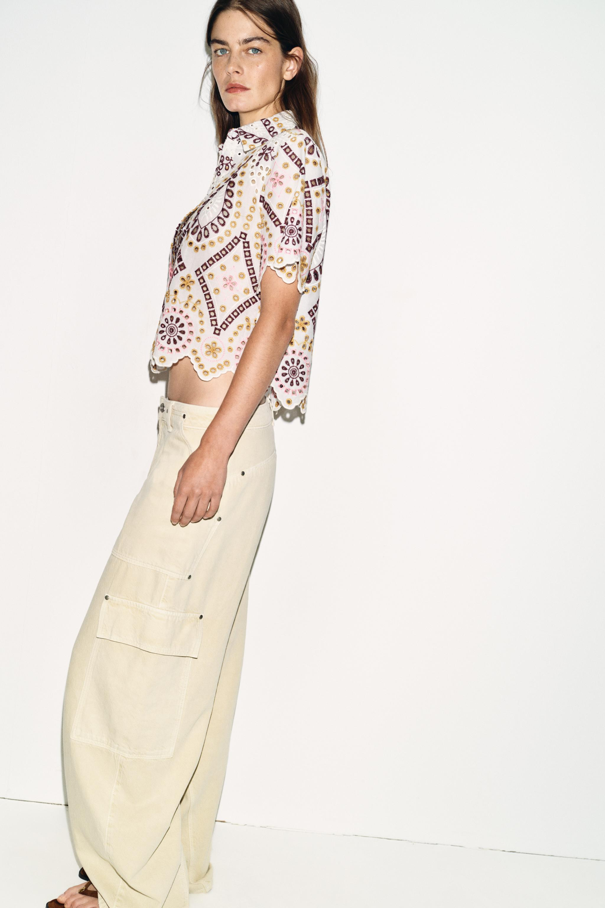 Cropped shirt with lapel collar and short sleeves. Features embroidered eyelet details. Front but... | Zara US