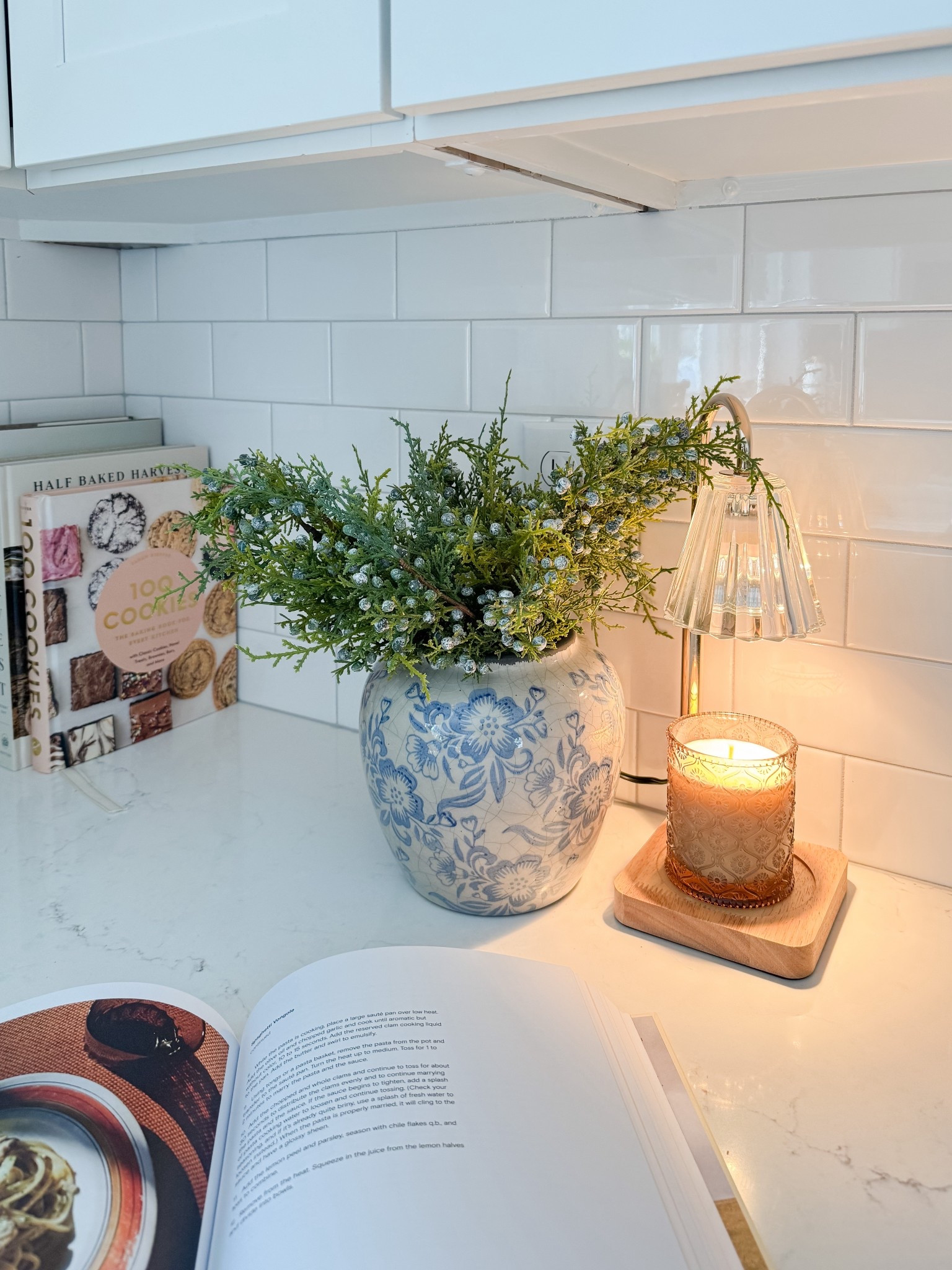 Cozy kitchen counter moment. This kitchen counter setup proves that simple details like cookbooks, greenery, and warm lighting can make everyday spaces feel welcoming.

Coastal kitchen decor, neutral kitchen, blue and white accents, cozy home details, simple styling, cape cod kitchen, everyday home inspiration, timeless design, Sherri calnan home

#LTKFindsUnder50 #LTKHome