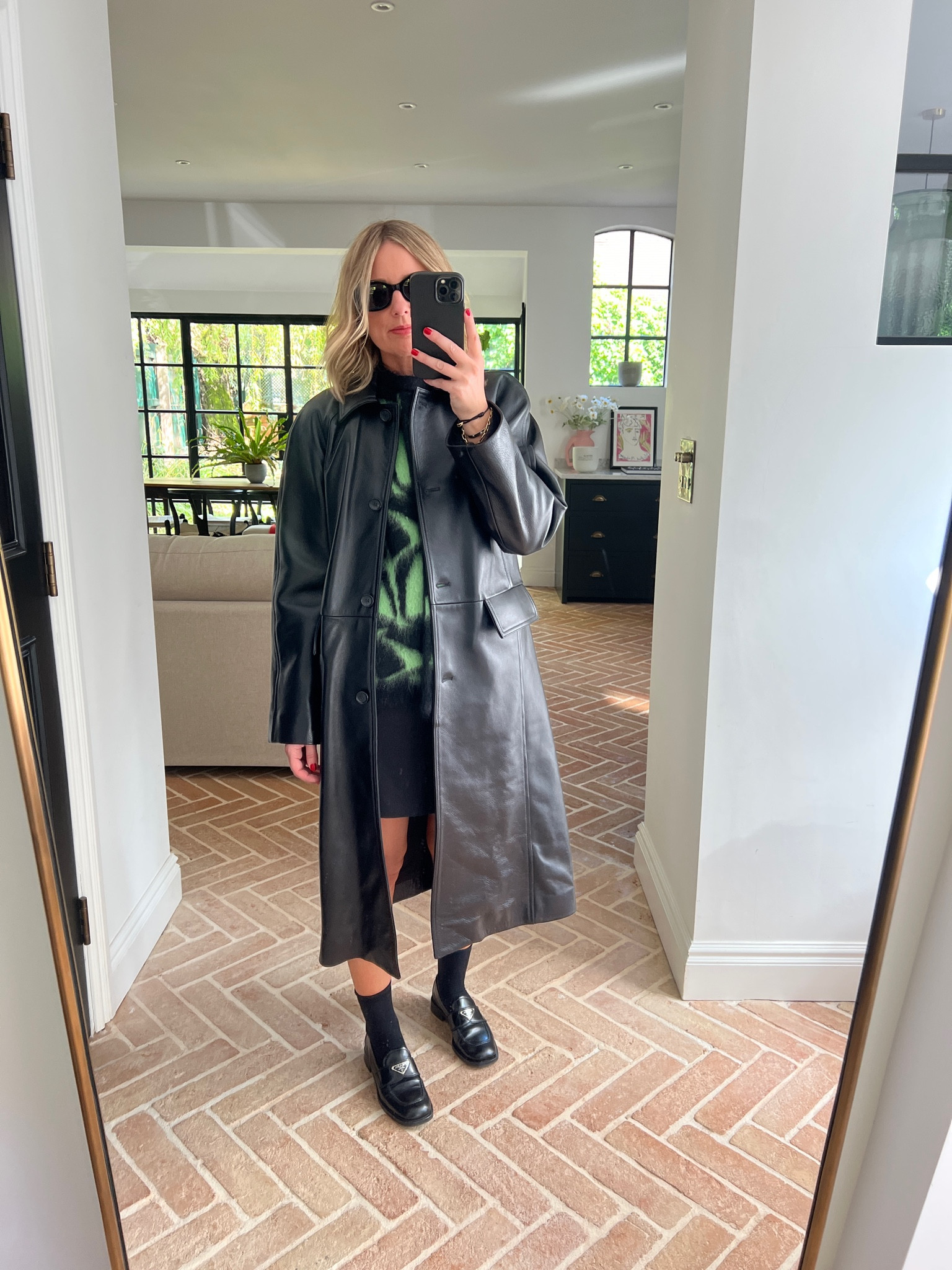 Long leather coat + chunky knit + mini skirt | Toteme | leather | Prada loafers 

#LTKover40 #LTKstyletip #LTKeurope