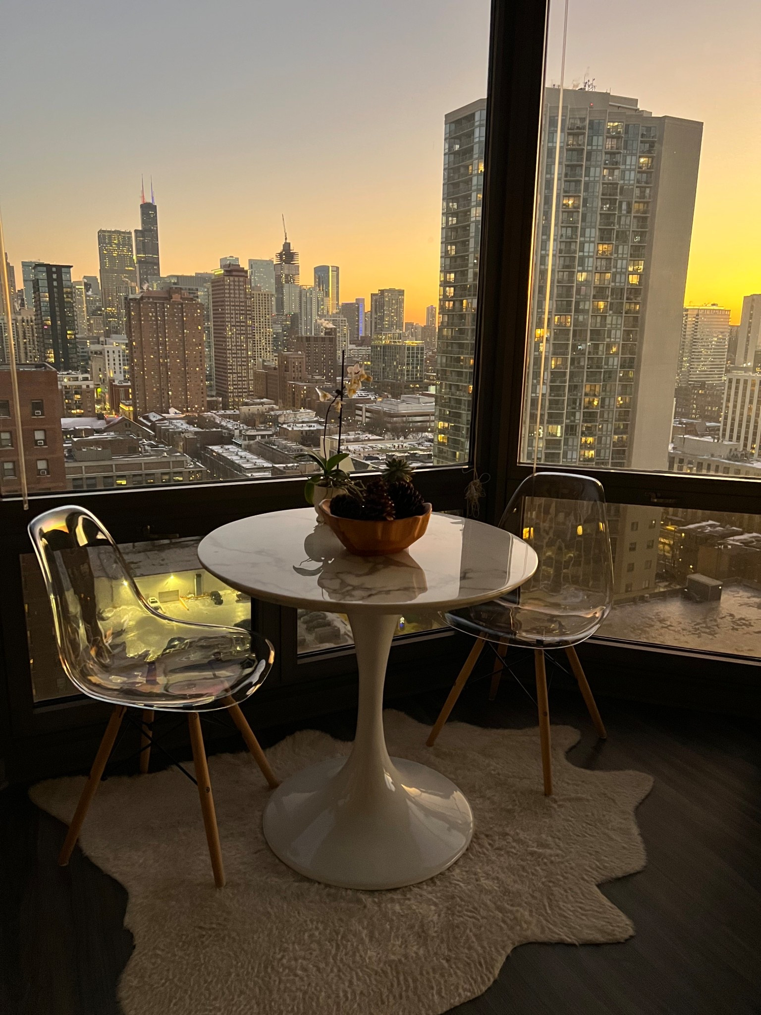 chicago downtown apartment decor - white marble table, neutral cowhide rug, decorative wood bowl

#LTKHome