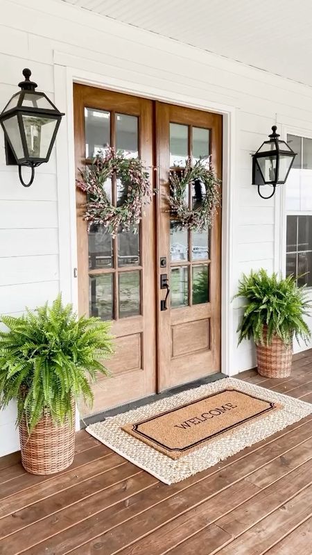 Spring porch front door decor entry curb appeal double layered jute scatter rug and welcome doormat  rattan wicker outdoor basket planters faux artificial ferns spring pink wreath outdoor lantern wall sconce lighting light fixtures modern farmhouse classic traditional home decor exterior home accents and accessories

#LTKSeasonal #LTKFind #LTKhome