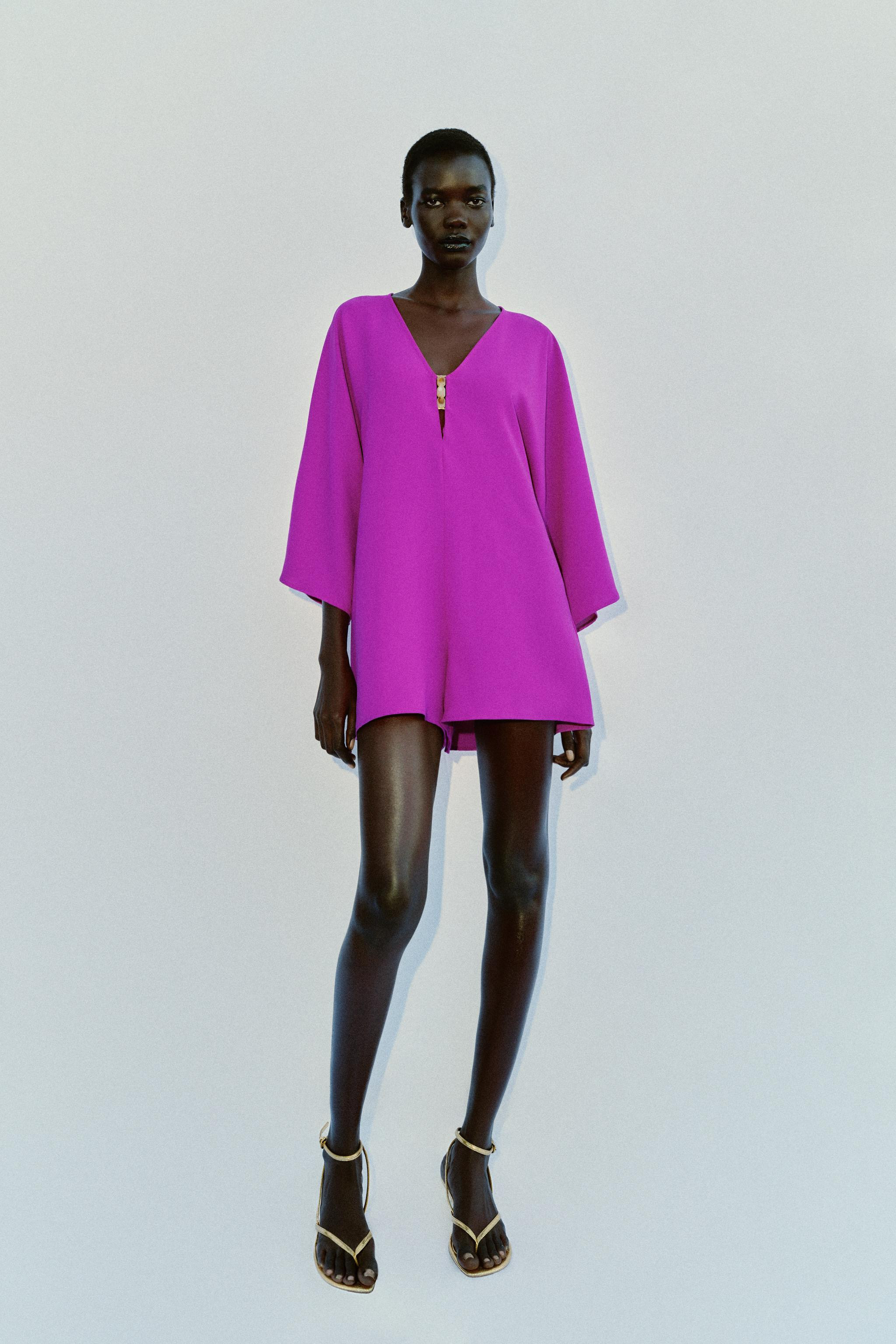Jumpsuit with V-neckline in front and back with trim. Long wide sleeves. Thin strap with bow at b... | Zara US