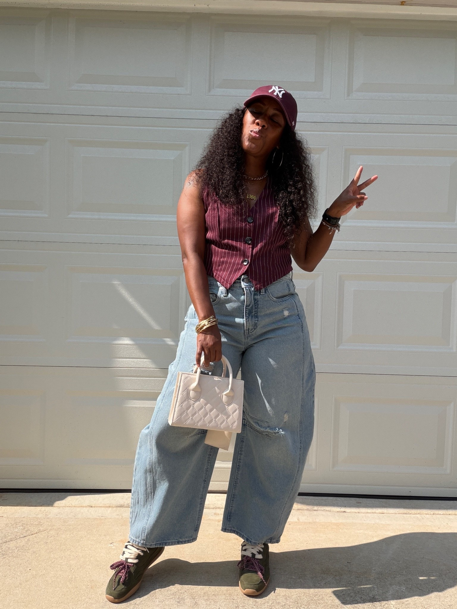 Barrel jeans and stripe vest outfit. I styled this casual outfit with a burgundy baseball hat, beige purse, and green faux suede double lace sneakers

#LTKootd #LTKOver40 #LTKPetite