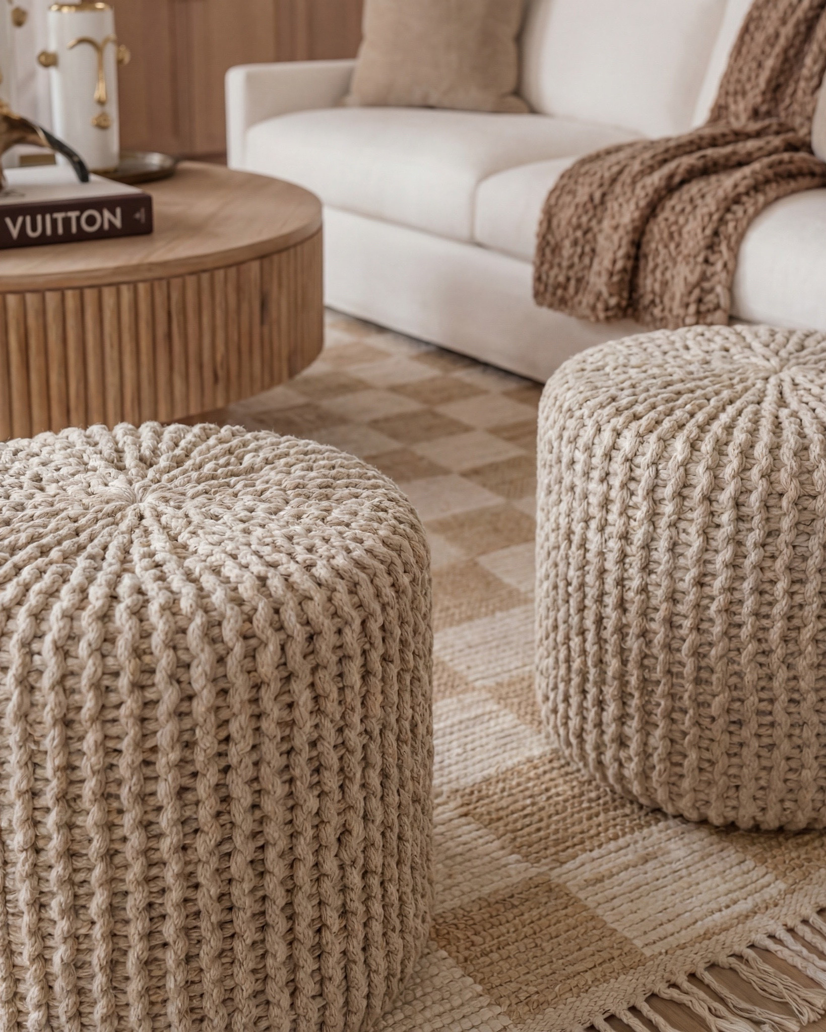 Shop the Look:
• Cream upholstered sofa
• Cream upholstered armchairs
• Round fluted wood coffee table
• Light wood side tables
• Neutral woven area rug (beige + ivory)
• Knitted pouf ottomans (natural tone)
• White globe pendant light with brass hardware
• Exposed wood ceiling beams
• Black arched window frames
• Sheer white curtain panels
• Marble fireplace surround
• Gold framed wall mirror (vintage style)
• Ceramic decorative vases (white + neutral)
• Brass decorative tray
• Sculptural brass bowl
• Coffee table books (fashion or design)
• Indoor potted tree (fiddle leaf fig or olive)
• Light wood flooring
• Neutral throw blanket (textured knit)

#LTKhome #LTKsale #LTKstyletip