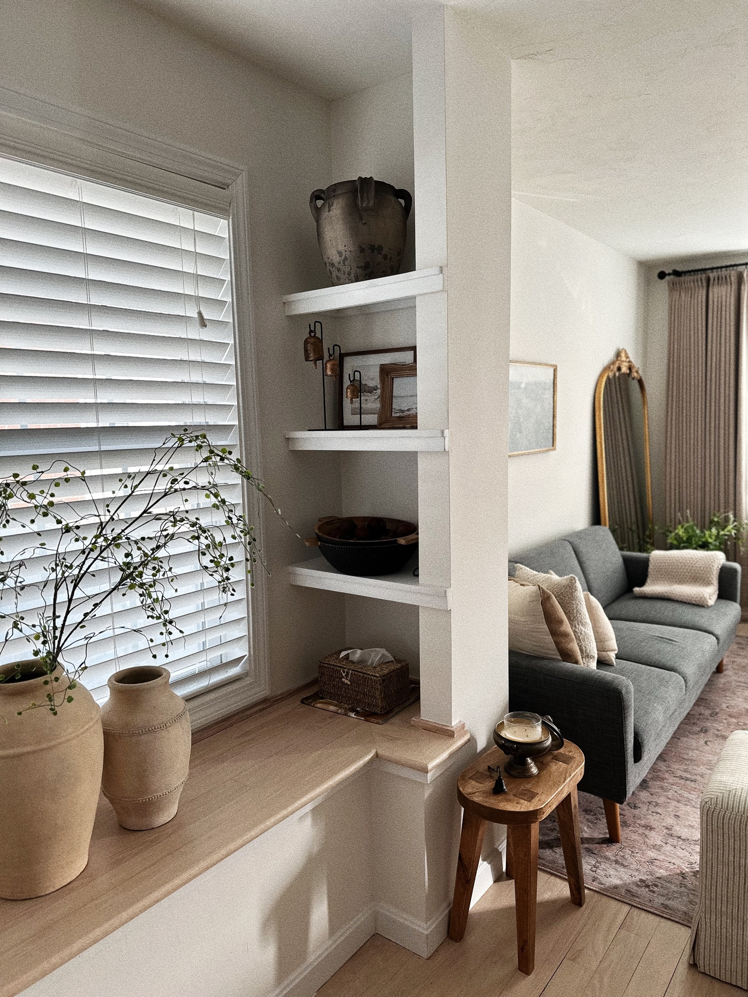 shelf styling with my new bells 😍😍😍
.
.
.
organic modern home, west elm couch, arhaus vase, target vases, hobby lobby stems, custom made curtains, loloi rugs 

#LTKstyletip #LTKhome #LTKsalealert