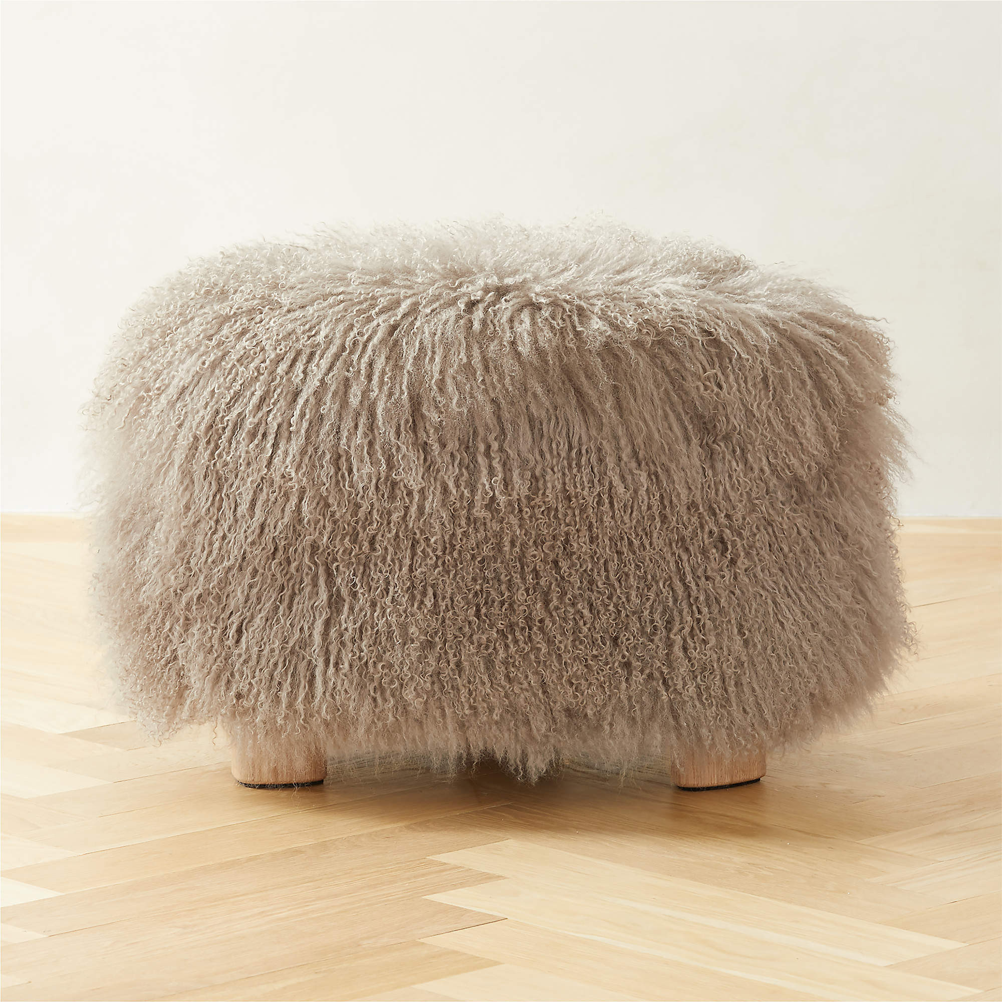 Bozzi Taupe Mongolian Sheepskin Ottoman by Ross Cassidy + Reviews | CB2 | CB2