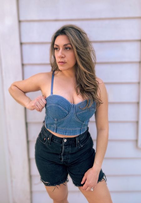 Who’s got Spring fever? 🌸🪻The light denim and black color combo is a classic look for spring. I love this bustier that gives me old school vibes with a built in bra! I got a medium for the larger cup size (similar to bra sizing). The shorts are the perfect length to start showing off your legs without being too short. The denim is a classic fit and feel, with just a little stretch to it. I’m wearing a 28. #ltkspring #springfling #springoutfits 

#LTKtravel #LTKSeasonal #LTKfindsunder100