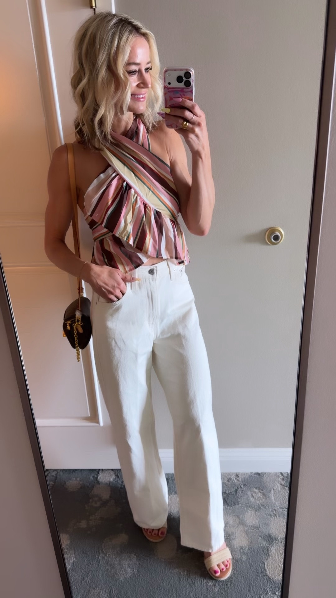 This tank is so fun and unique! Halter that buttons behind the neck and ties in the back. Cinch snap baggy Levi’s in the perfect cream color, paired with wedges and the LV mini bum bag

#LTKOver40 #LTKTravel #LTKootd