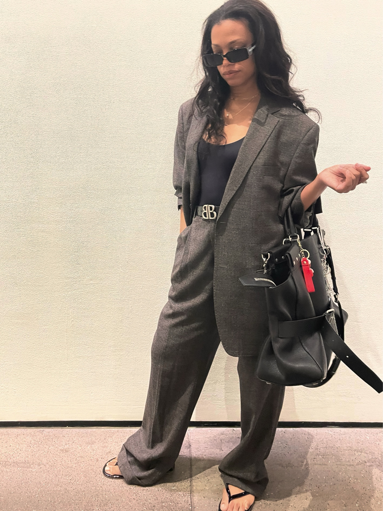 Dress up menswear with leather detail and silver hardware. A bodysuit under your oversized blazer balances the look!