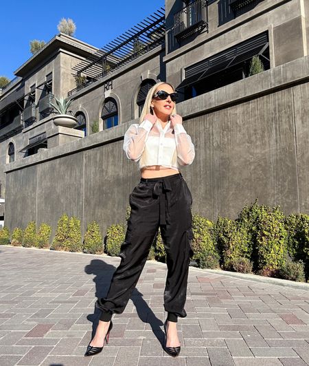 2023 spring trends include cargo pants and sheer tops & dresses. This sheer white button down shirt comes with the matching bandeau tops. Black satin cargo pants are easy to dress up or down. 

#LTKFind #LTKstyletip #LTKSeasonal