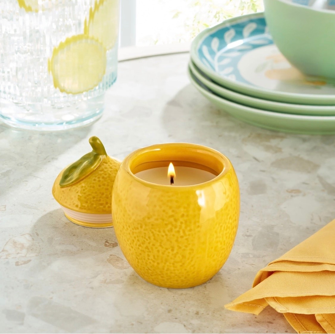 Bring a playful touch to your home with the Better Homes & Gardens Lemon Shaped Ceramic Candle. This delightful 6-ounce figural candle pairs refreshing notes of lemon and mint with a cheerful citrus-inspired design that brightens kitchens, dining spaces, and cozy nooks alike. Nestled in a glossy ceramic vessel bursting with charm, it becomes an eclectic decor piece long after the candle is finished. Let yourself unwind with its inviting glow or use a candle warmer lamp for an easy, flameless way to enjoy scented candles at home. Perfect for gifting or adding a dash of whimsy to your space, this vibrant accent fills any room with warmth and welcoming aroma

#LTKmorningroutine #LTKselfcare #LTKdayinmylife