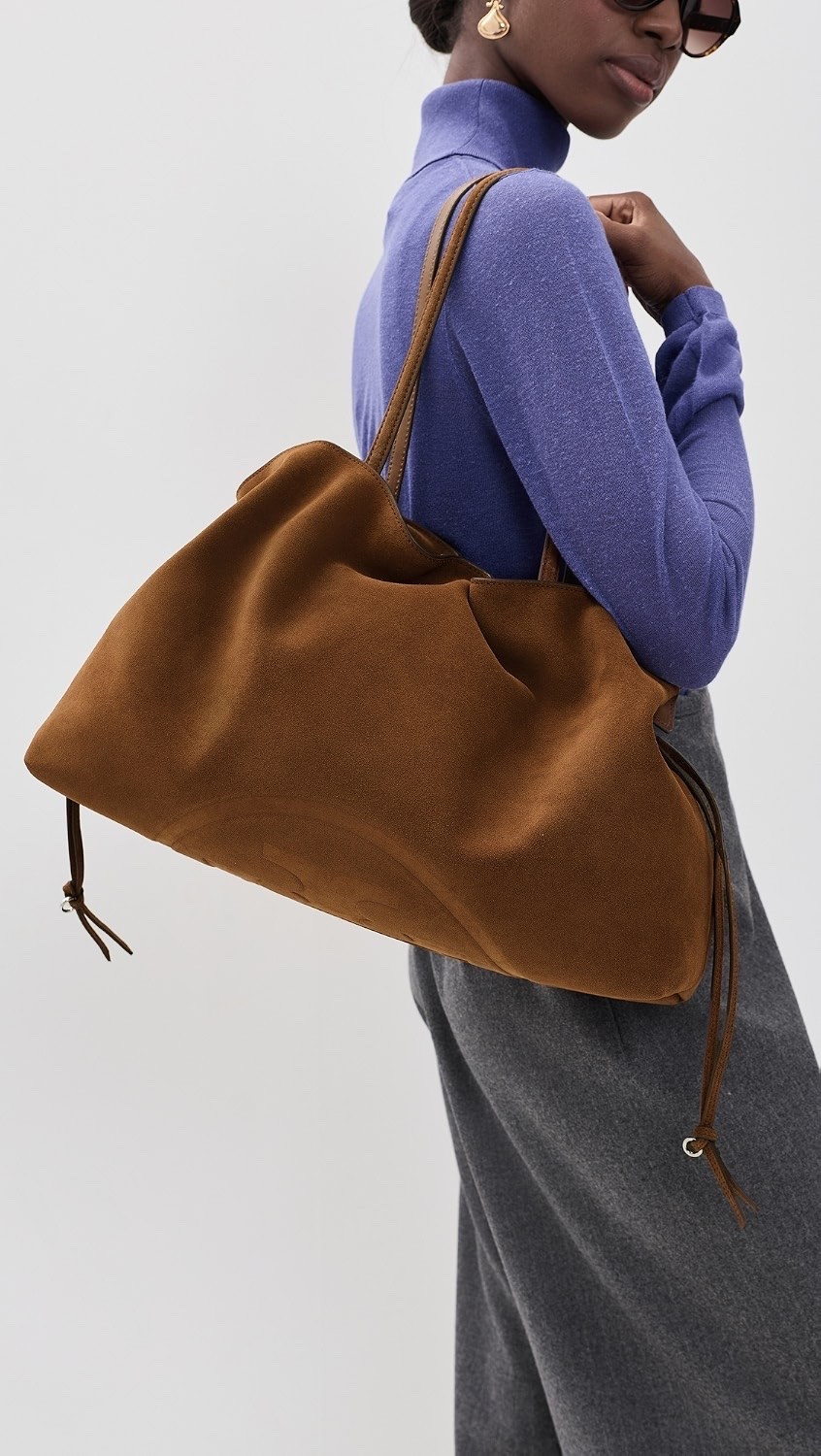 Tory Burch
Ella Suede Drawstring Tote

This Tory Burch tote is crafted from suede and features an embossed logo accent, an open top with magnetic closure, and shoulder straps.

#LTKootd #LTKTravel #LTKWorkwear