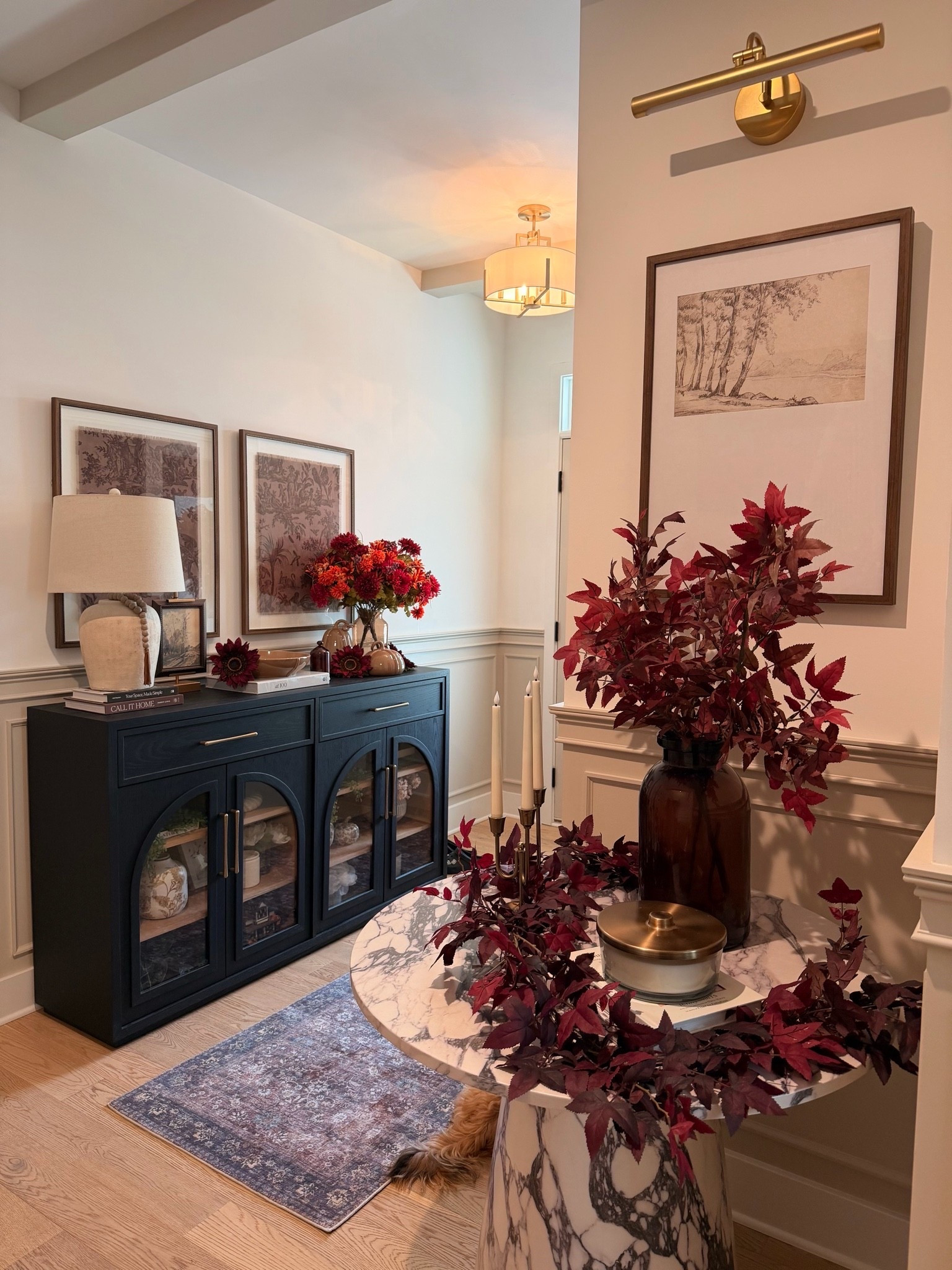 Moody fall tones are officially making their way into our home. 🍂🍁 I layered rich burgundy stems, warm brass accents, cozy candlelight, and timeless artwork to create an entryway that feels elegant, inviting, and ready for the season. Shop all of my fall styling favorites, decor, and home details linked here! 🤎

#LTKSeasonal #LTKHome #LTKSaleAlert