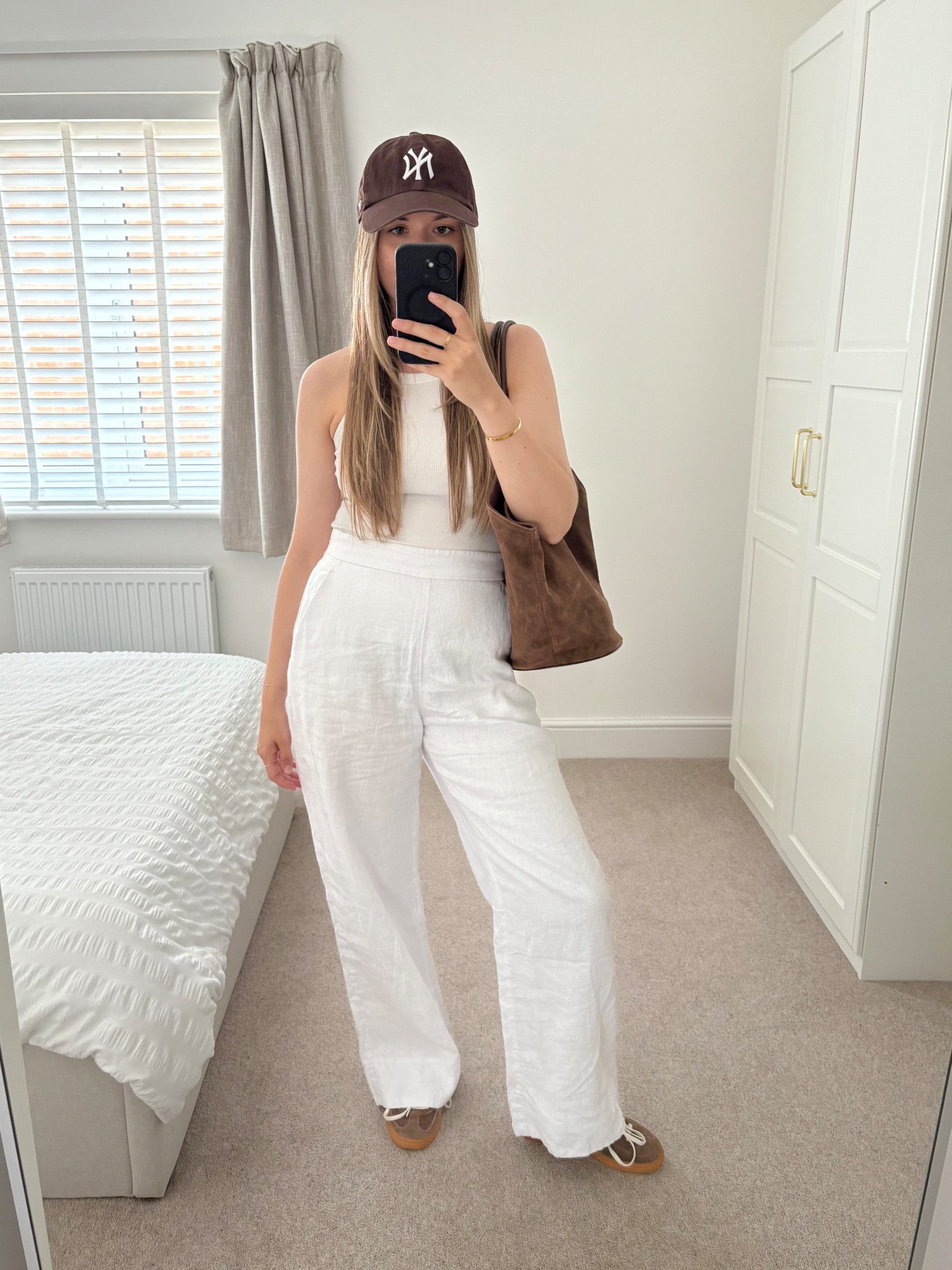 Ways to wear white linen trousers 🤍

My favourite kind of weekend casual look. 

Brown cap, white vest top, brown adidas trainers and brown suede tote bag. 

#LTKsummer #LTKuk #LTKstyletip