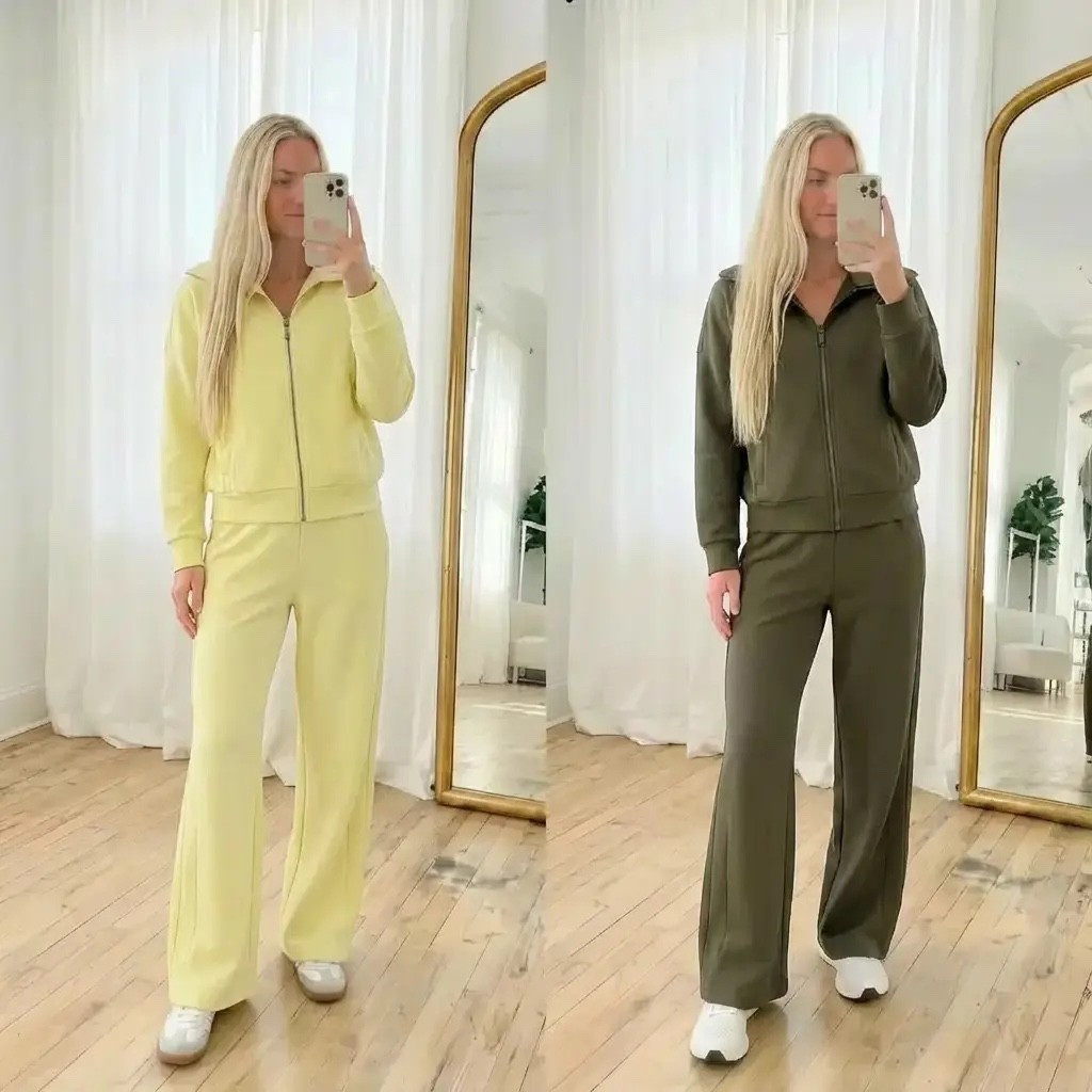 A clean, minimalist fashion mirror selfie featuring the same woman styled in two monochrome lounge sets side-by-side. On the left, she wears a soft pastel yellow zip-up hoodie with matching wide-leg sweatpants and white sneakers. On the right, she wears an olive green zip-up hoodie with coordinating wide-leg pants and white sneakers. Her long, straight blonde hair falls naturally, partially covering her face as she holds a phone. The setting is a bright, airy room with sheer white curtains, warm natural light, light wood floors, and a tall gold-framed mirror. The overall aesthetic is cozy, elevated athleisure with a neutral, modern, Pinterest-worthy vibe—effortless, calm, and stylish.

⸻

HASHTAGS

#athleisurewear #loungewearstyle #monochromeoutfit #cozychic
#casualstyle #effortlessfashion #neutralstyle #everydayoutfits
#minimalfashion #softaesthetic #widelegpants #zipuphoodie
#comfortablefashion #cleanstyle #modernminimal #athleisurelooks
#trendystyle #mirroroutfit #simpleoutfits #quietluxurystyle

#LTKdayinmylife #LTKHoliday #LTKGiftGuide