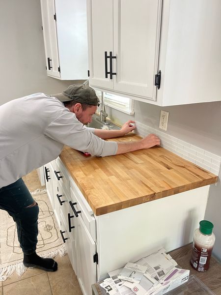 Quick kitchen remodel as we get ready to list our house next week! We replaced the countertop, sink and faucet, added peel and stick tile backsplash, painted the cabinets and updated the hardware 🛠️ It’s looking so much more modern in here for around $600 

#LTKHome #LTKStyleTip