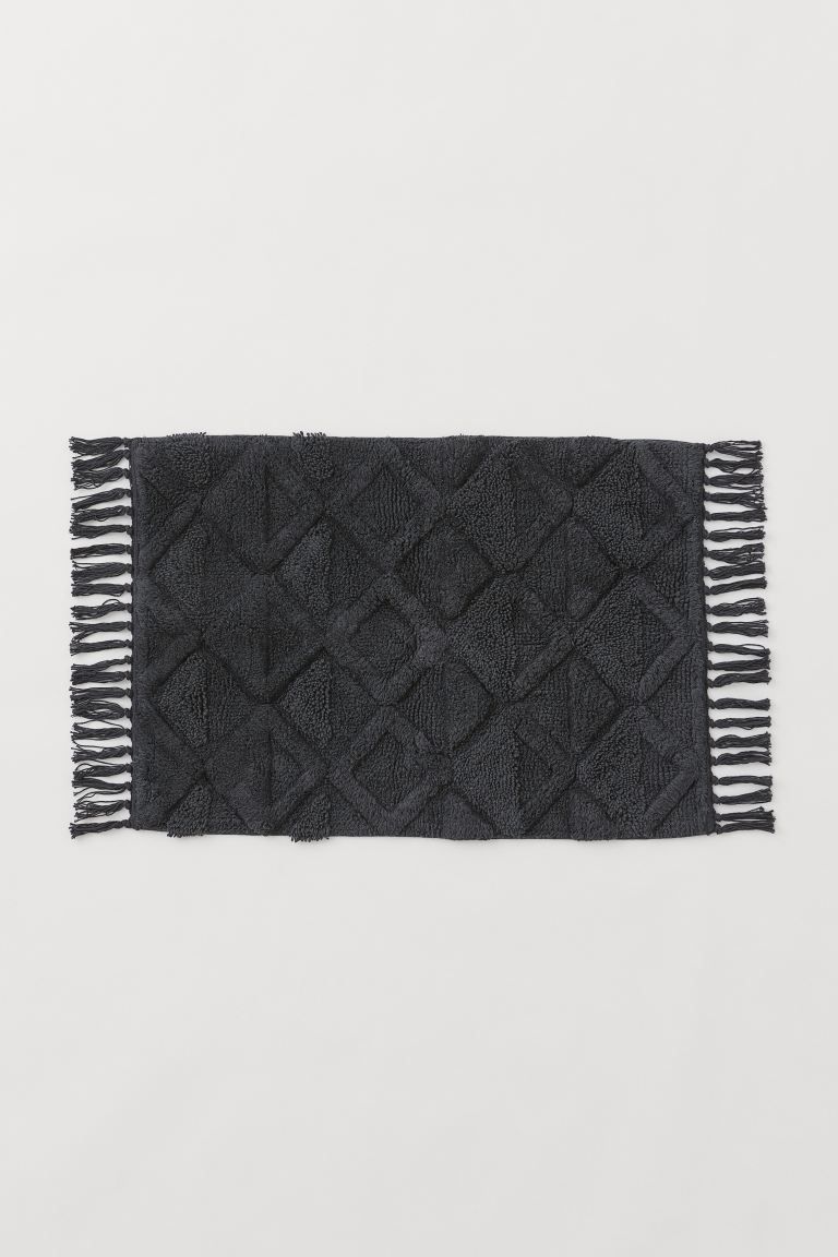 Bath mat in thick cotton terry with a tufted tone-on-tone pattern, fringe at short sides, and non... | H&M (US + CA)