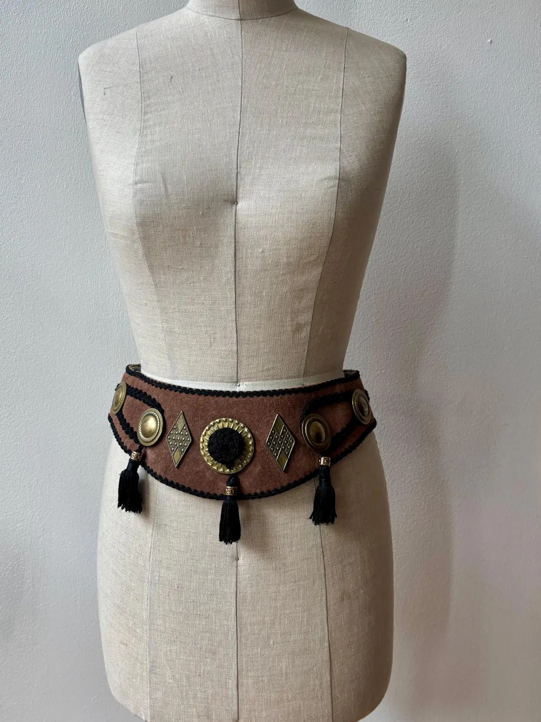 Brown faux suede belt with black corded, trim, and embellishment.  Brass medallions and black cor... | Etsy (US)