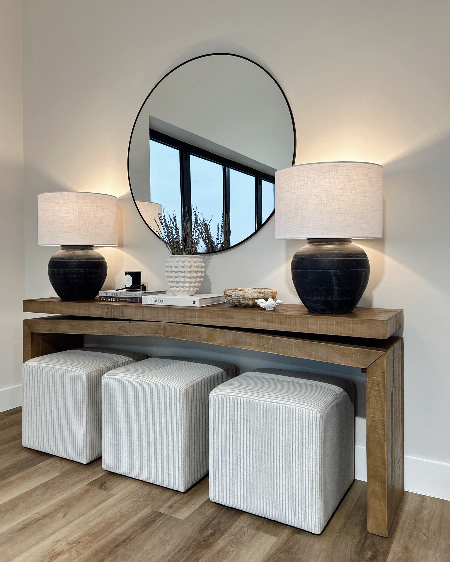 Console table styling 🤎
I’ve loved this oversized rustic console table for years! I styled it with an oversized mirror and Pottery Barn lamps, cube ottomans, coffee table books, candles, a stone bowl, and preserved lavender in the prettiest textured vase. I’ve linked as many exact finds as possible! This particular vase, bowl, and candles were Home Goods finds  

#LTKHome