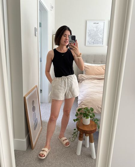 Tank: Everlane. Tts
Shorts: Reformation Zoey shorts. Tts
Slides: I’m usually a 7 and these are 6/7. Fits perfectly 

Linen shorts. Summer slides. Casual outfit. Neutral outfit 