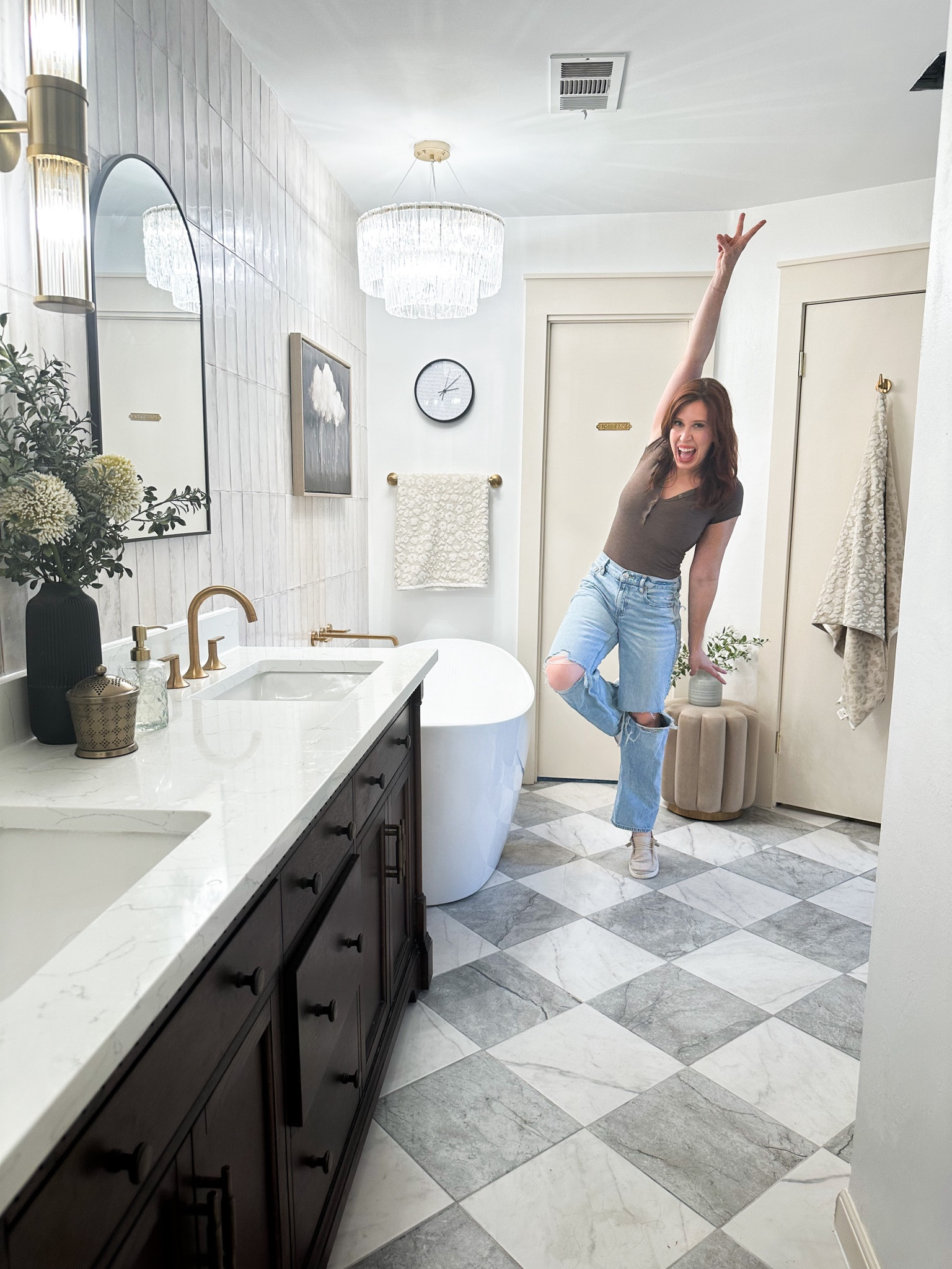 Posing with my newly completed primary bathroom! This was a DIY remodel from top to bottom and it is now a luxurious neutral dream. Had to change out of my project clothes and into a cute body suit and straight leg jeans to celebrate the reveal! #bathroominspo #harlequinfloors #fallstyle #bathroomdecor #affordablelightfixtures

#LTKHome