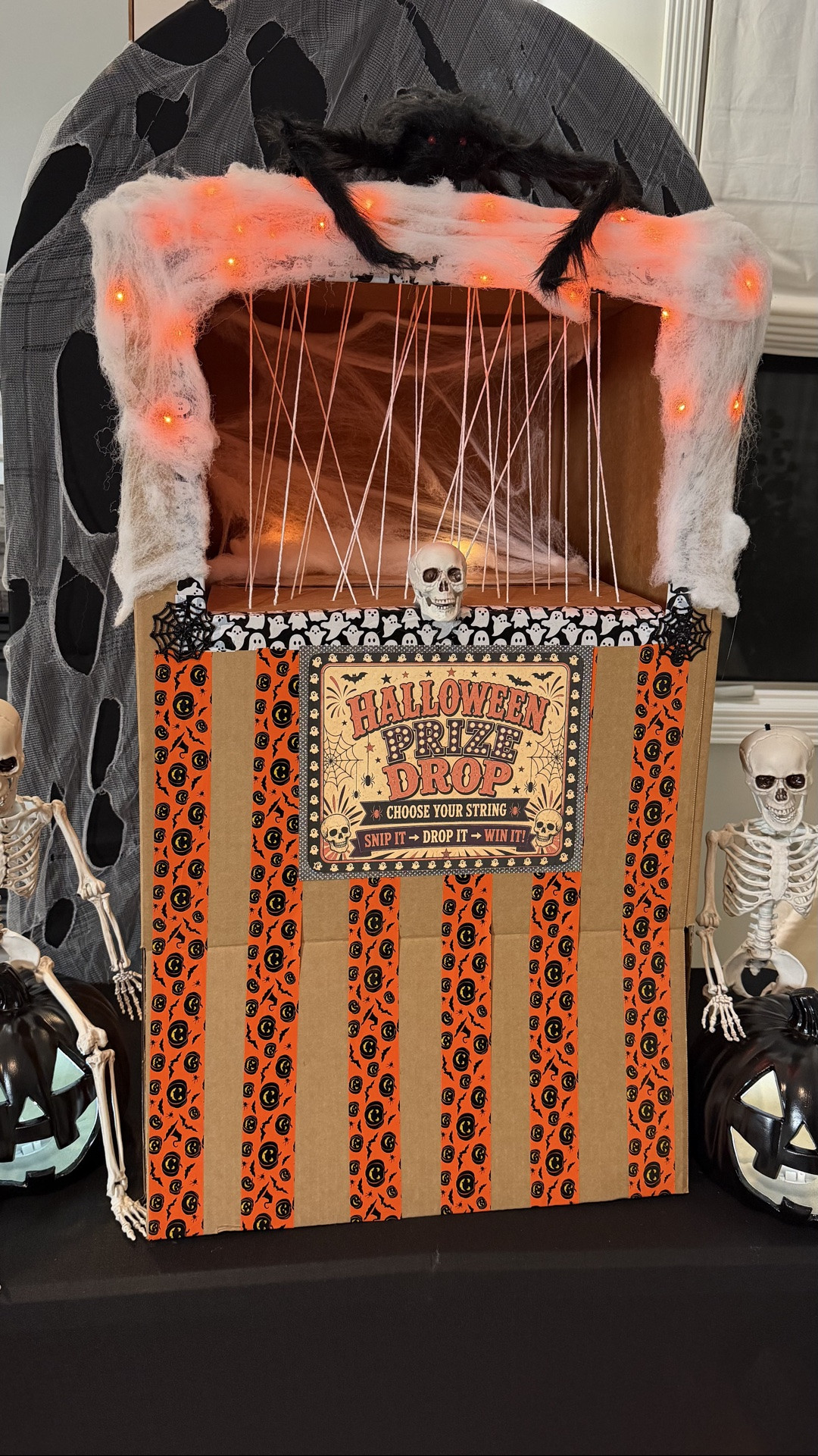 Apparently, I wasn’t done with the prize machine… 🕸️🕷️🎃

After all your suggestions from my 4th of July version, I took your ideas and gave it a Halloween makeover — added the spider, string lights, more details around the top, and turned it into a full-on Halloween Prize Drop! 

And let me tell you… the boys LOVED it. 

This was for my son’s birthday party, and honestly, the prize machine was a bigger hit than any traditional party favor could have been. They were cutting strings, cheering when prizes dropped, and immediately going back for another turn.

The prizes included NeeDohs, cash, gift cards, candy, and more — so there was a little something for everyone.

And to everyone who gave me ideas on the first version… THANK YOU! ❤️ Your suggestions seriously helped make version 2 even better.

#LTKSeasonal