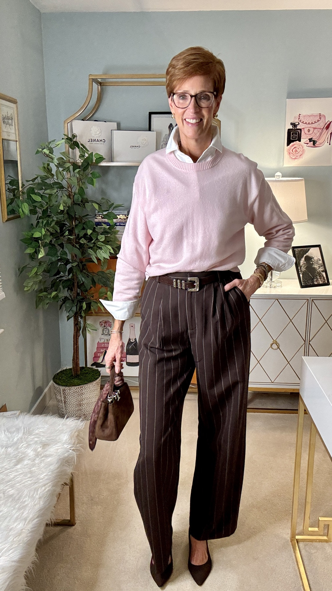 At 56, I don't want pink to feel precious. I want it to look like this.

Want the links sent to you? Comment PINK and I’ll DM them!

Soft pink cashmere layered over a crisp white oxford, brown pinstripe wide-leg trousers, pointed-toe suede heels and a structured suede bag. The menswear-inspired trousers and rich chocolate brown keep the pink from feeling overly sweet — and make this one of those polished fall outfits I could wear again and again.

And at 6'1", trousers are always part of the equation for me. These have the long, fluid silhouette I look for, and pairing them with a crewneck cashmere sweater makes the whole outfit feel elevated without being complicated.

This is exactly what I mean when I talk about building a fall wardrobe around pieces that work together: a great cashmere sweater, a white button-down, trousers and brown accessories. Nothing complicated. It's the combination that makes it interesting.

Would you wear pink with brown? Tell me below — because I think this color combination deserves a lot more attention this fall.

Save this one for your fall outfit ideas, and send it to someone who would wear this combination too.

#FallStyleOver50 #CashmereStyle #TallWomenStyle

#LTKootd #LTKOver40 #LTKTall