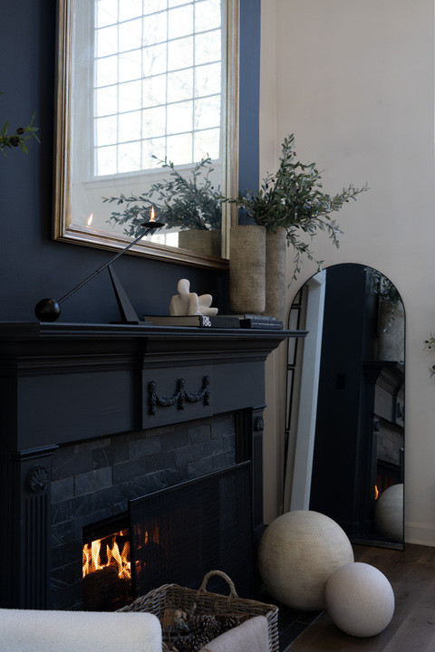 I cannot get over this minimalist candlestick moment!! That clean modern metal silhouette on the mantel adds the perfect contrast and makes the fireplace styling feel curated and sophisticated. The warm flame glow with the neutral decor makes this space feel cozy but seriously luxury! 

 #LTKOver40 #LTKHome #LTKSaleAlert