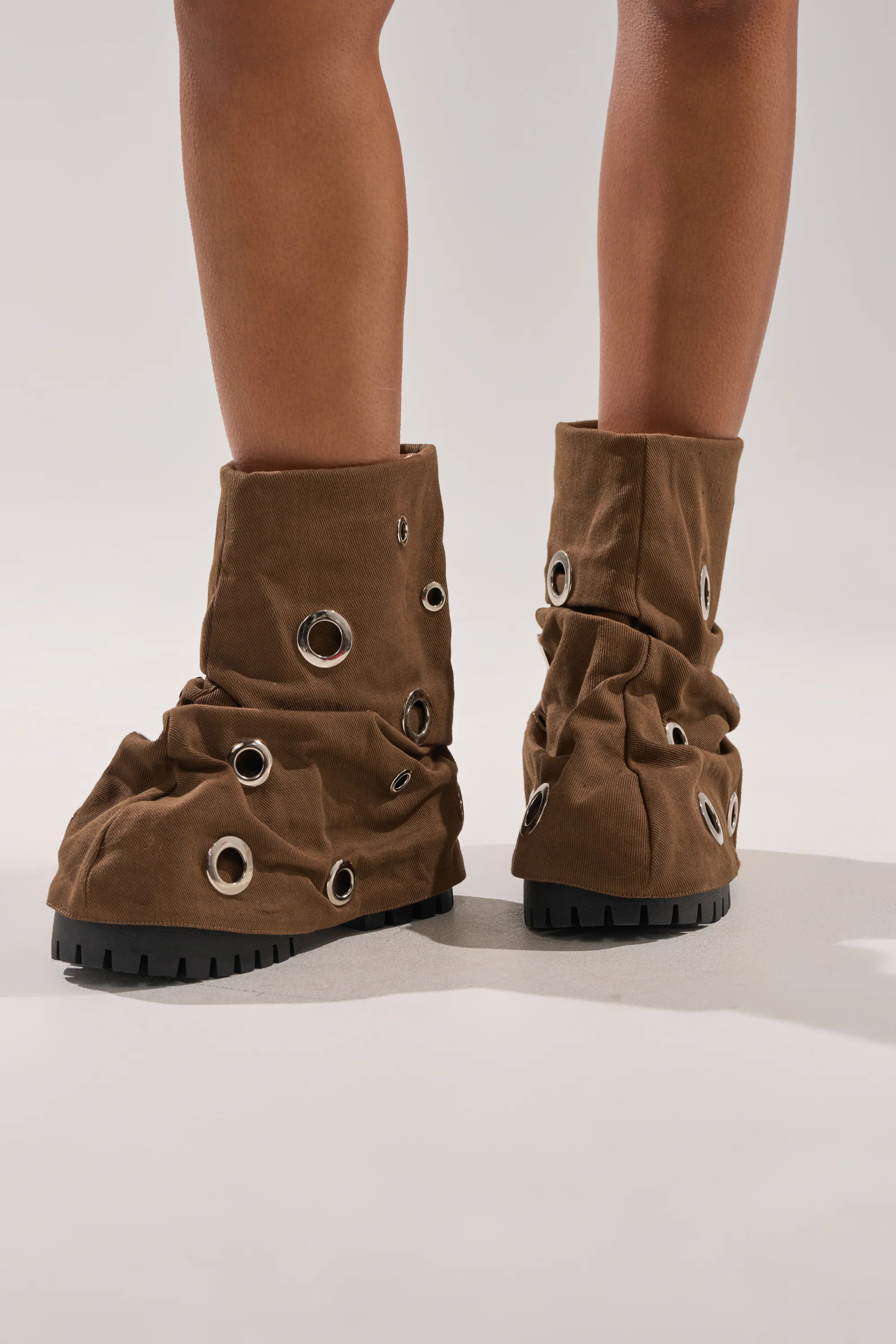 AKIRA GOLD FABLE BROWN GROMMET EMBELLISHED FLAT BOOTIE | AKIRA