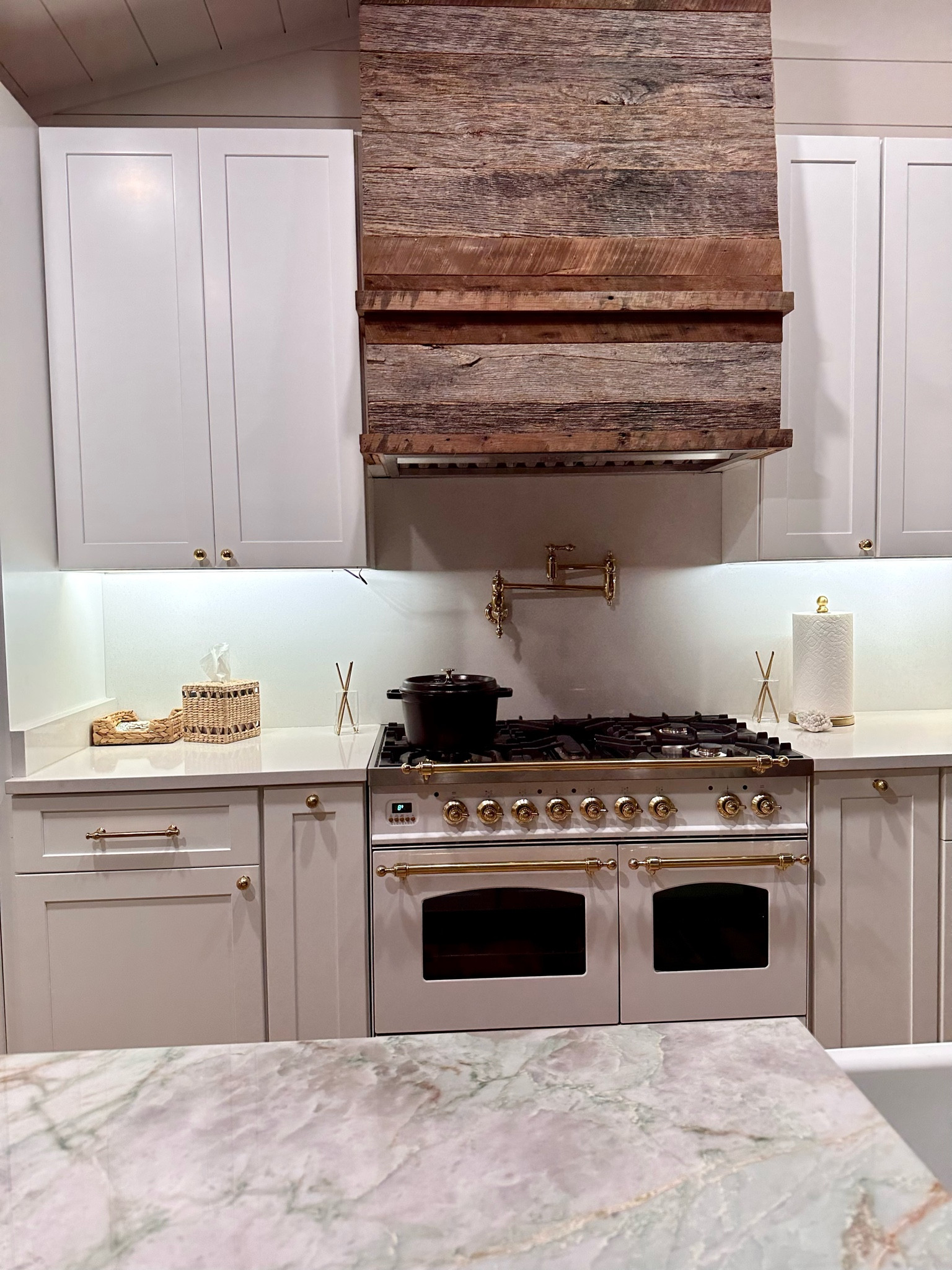 White and gold kitchen with reclaimed wood hood and brass hardware. Ilve oven, gold paper towel, rejuvenation hardware.

#LTKstyletip #LTKhome #LTKfindsunder50